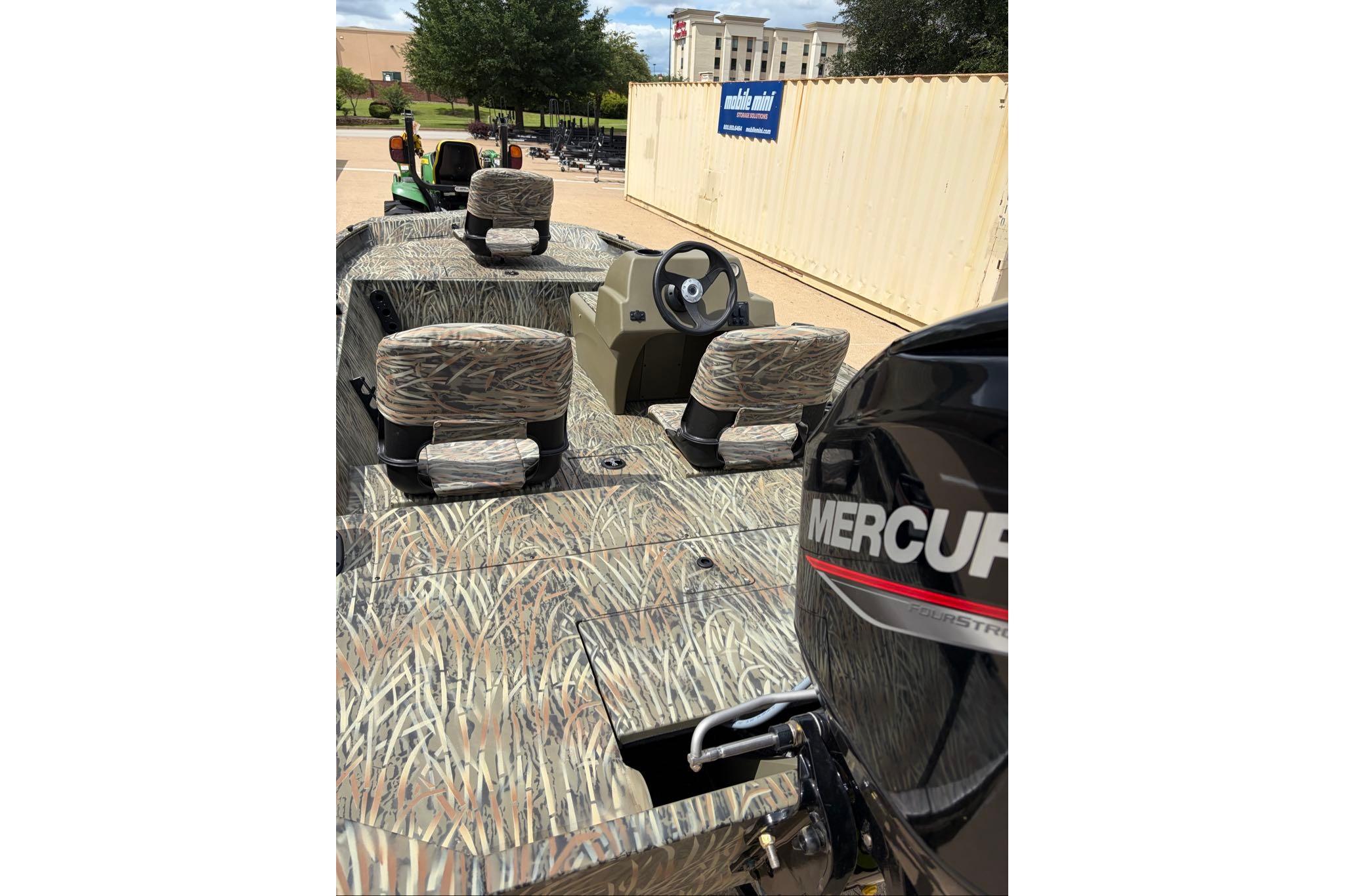 2026 Tracker Grizzly 1754 SC boat with camo seats and Mercury engine.