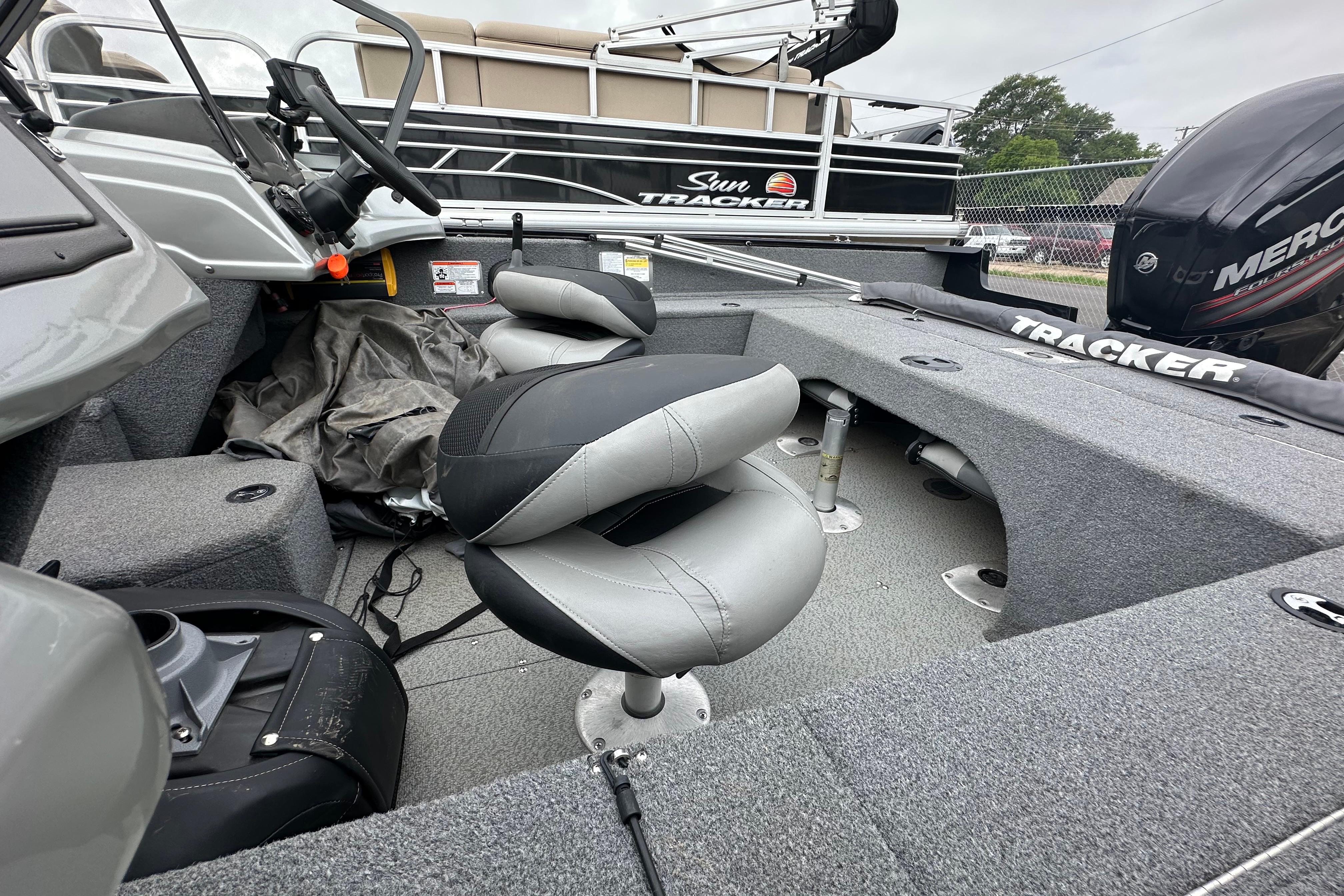 2018 Tracker Pro Guide V-175 Combo boat interior with seating and steering wheel.