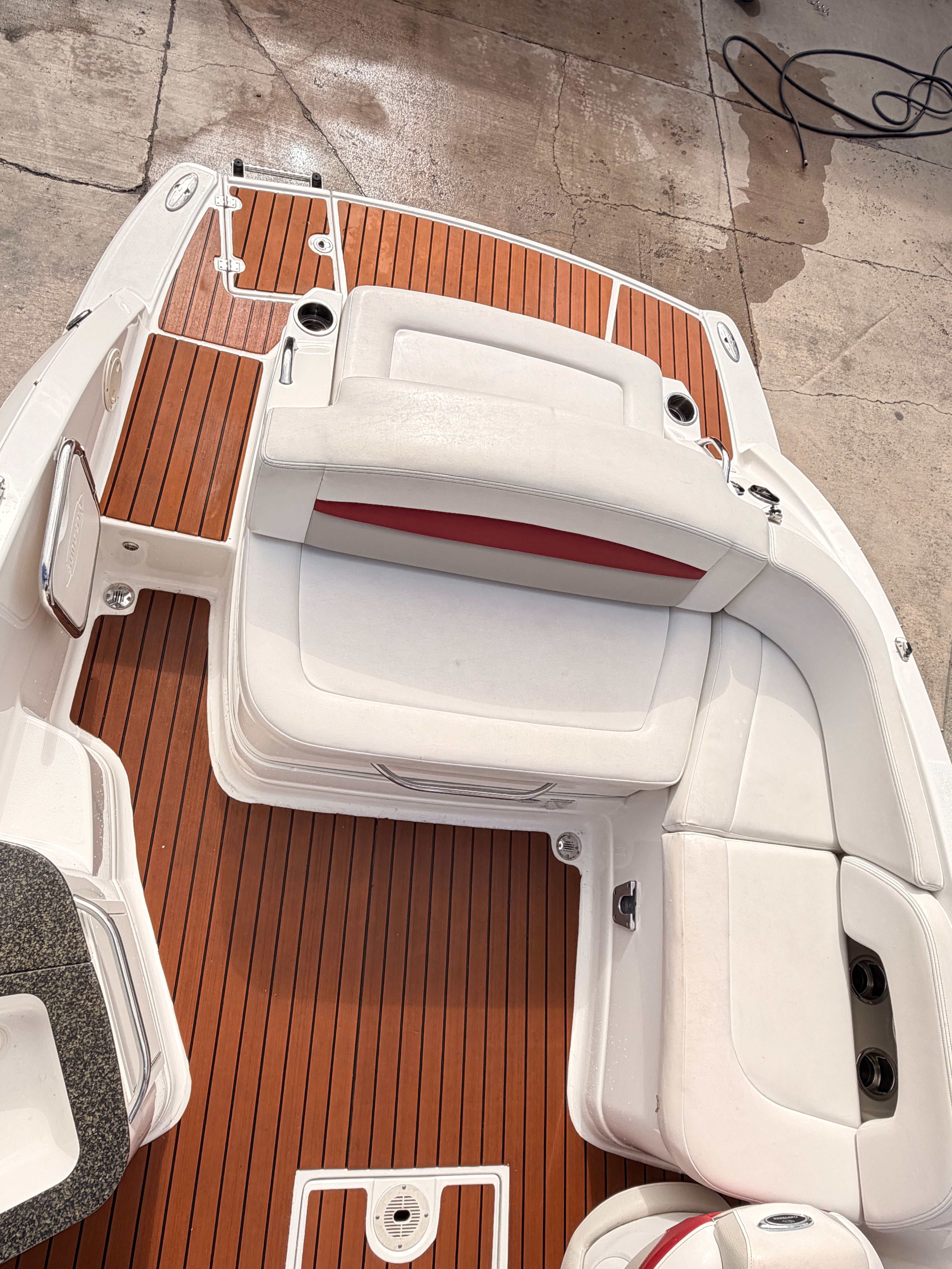 The image shows the cockpit of a 2008 Chaparral Sunesta 224 with white and red seating.