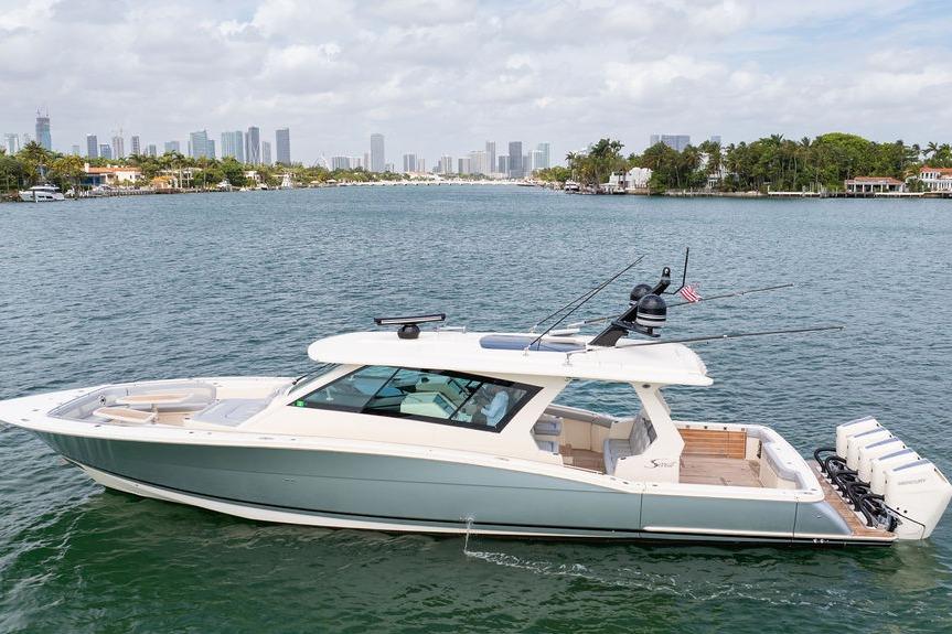 2020 Scout 530 LXF luxury boat cruising near city skyline.