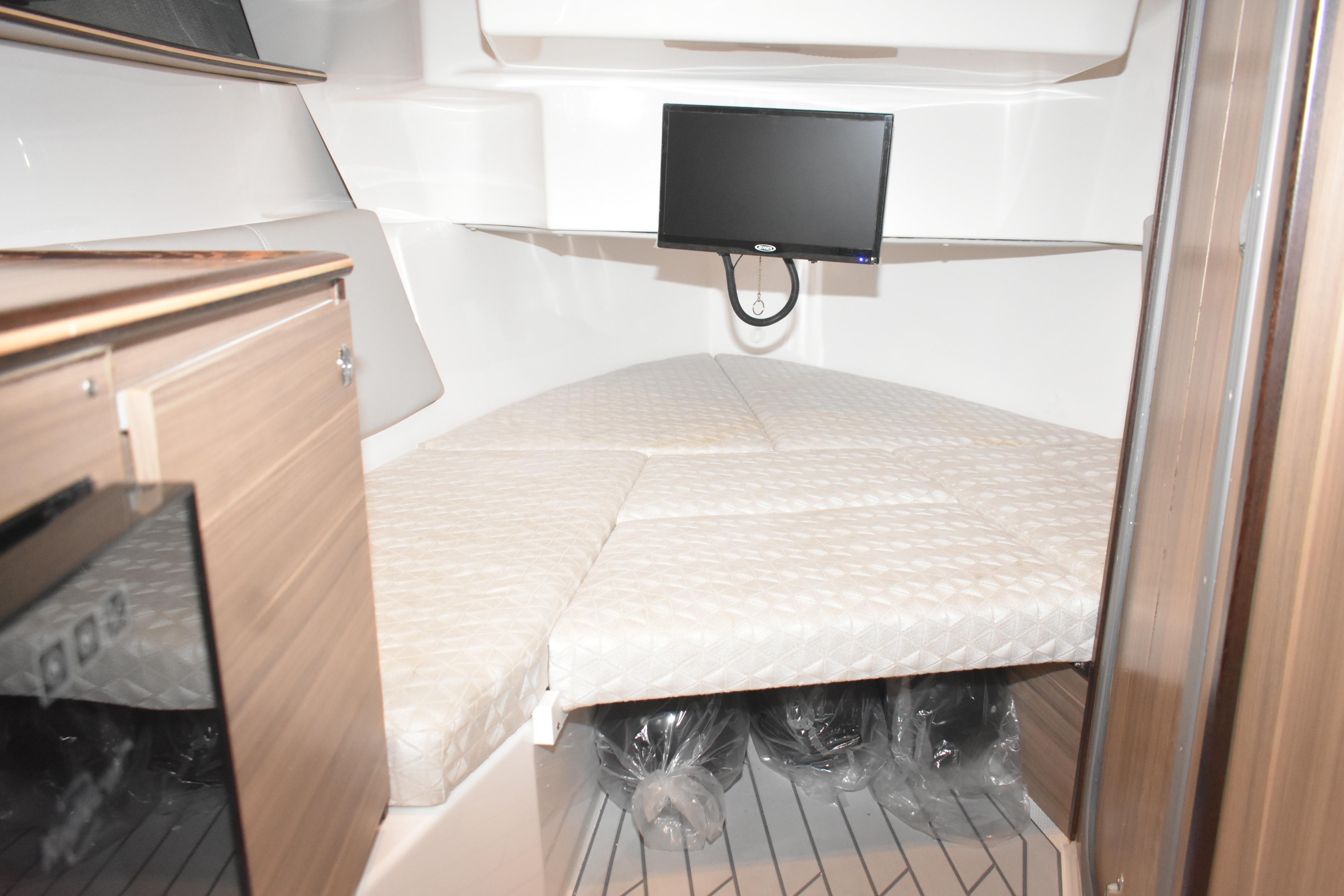 2025 Solara S-310 CW cabin interior with bed and mounted TV.