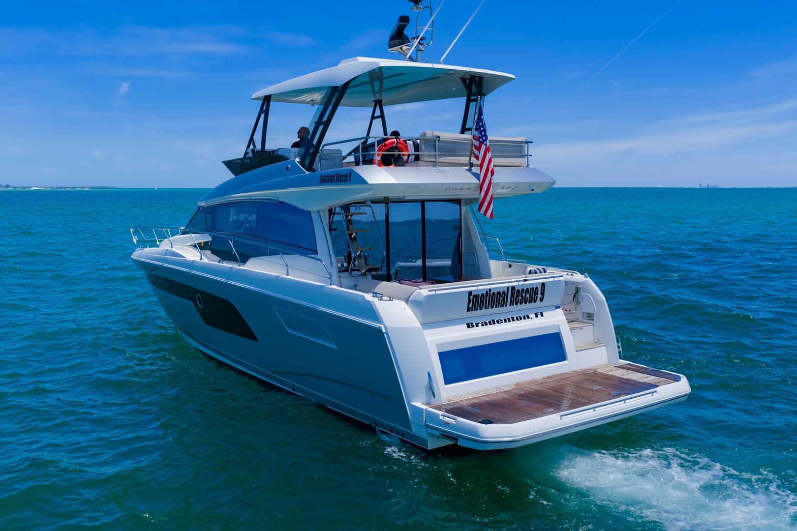 Luxury 2022 Prestige 520 yacht cruising in clear blue ocean waters.