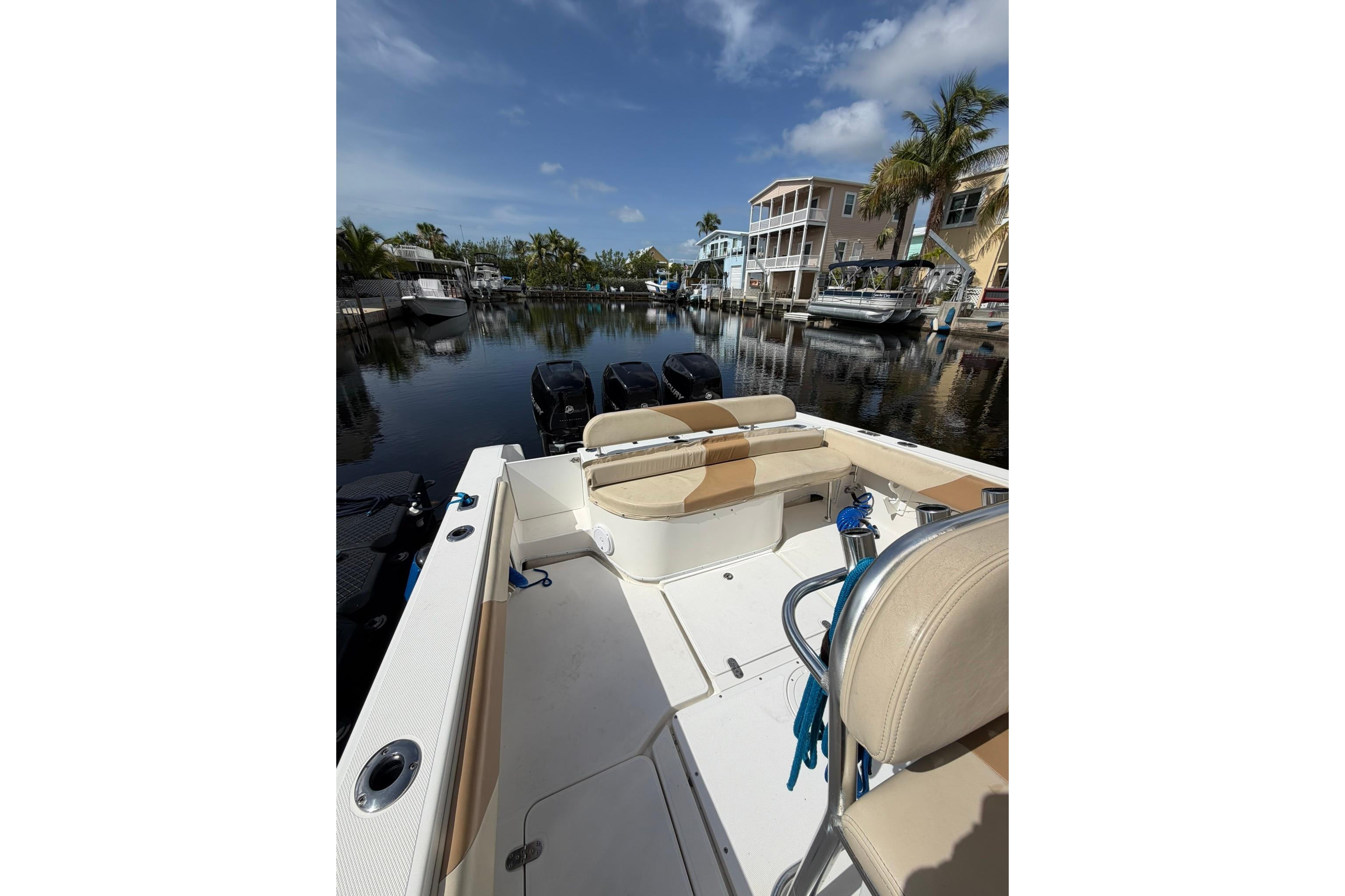 2007 Fountain 34 Center Console boat docked in a scenic marina setting.