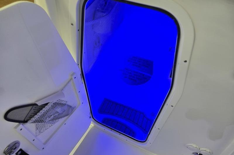 Interior view of 2026 Sea Hunt Ultra 275 Coffin Box with blue lighting.