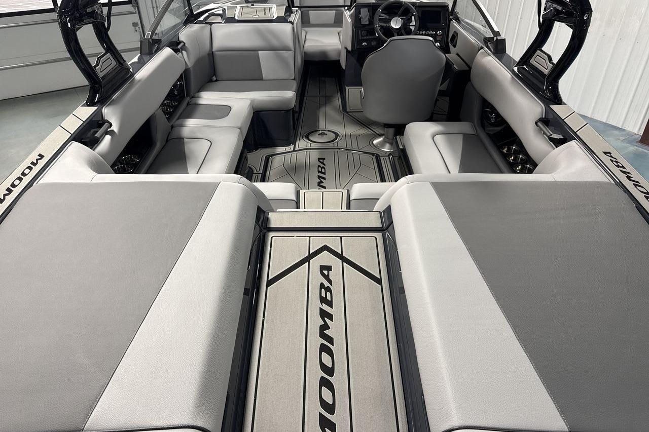 Interior view of a modern Moomba Craz boat with gray upholstery and sleek design.