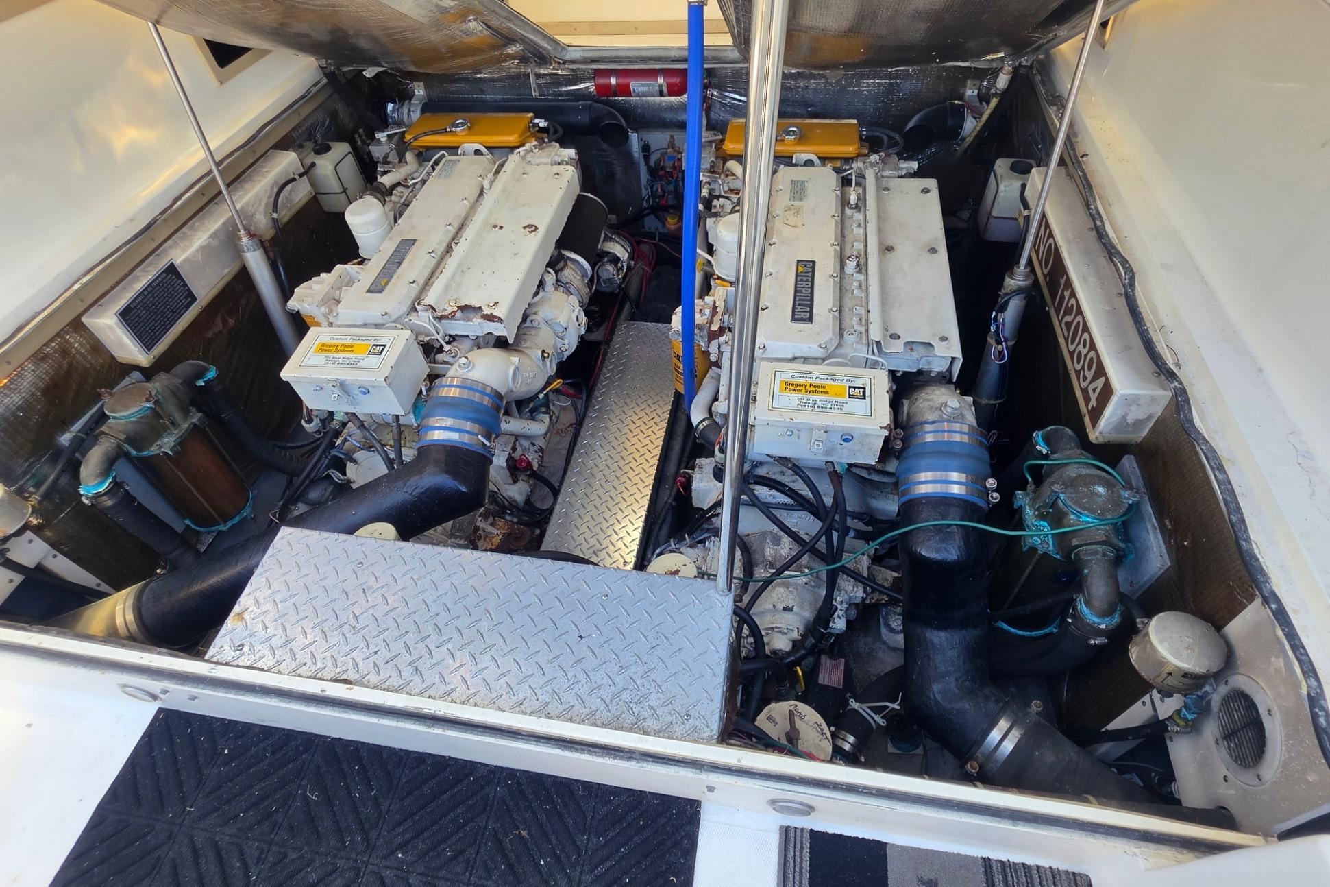 Engine compartment of a 1999 Albemarle 305 Express Fisherman boat, showcasing dual engines.