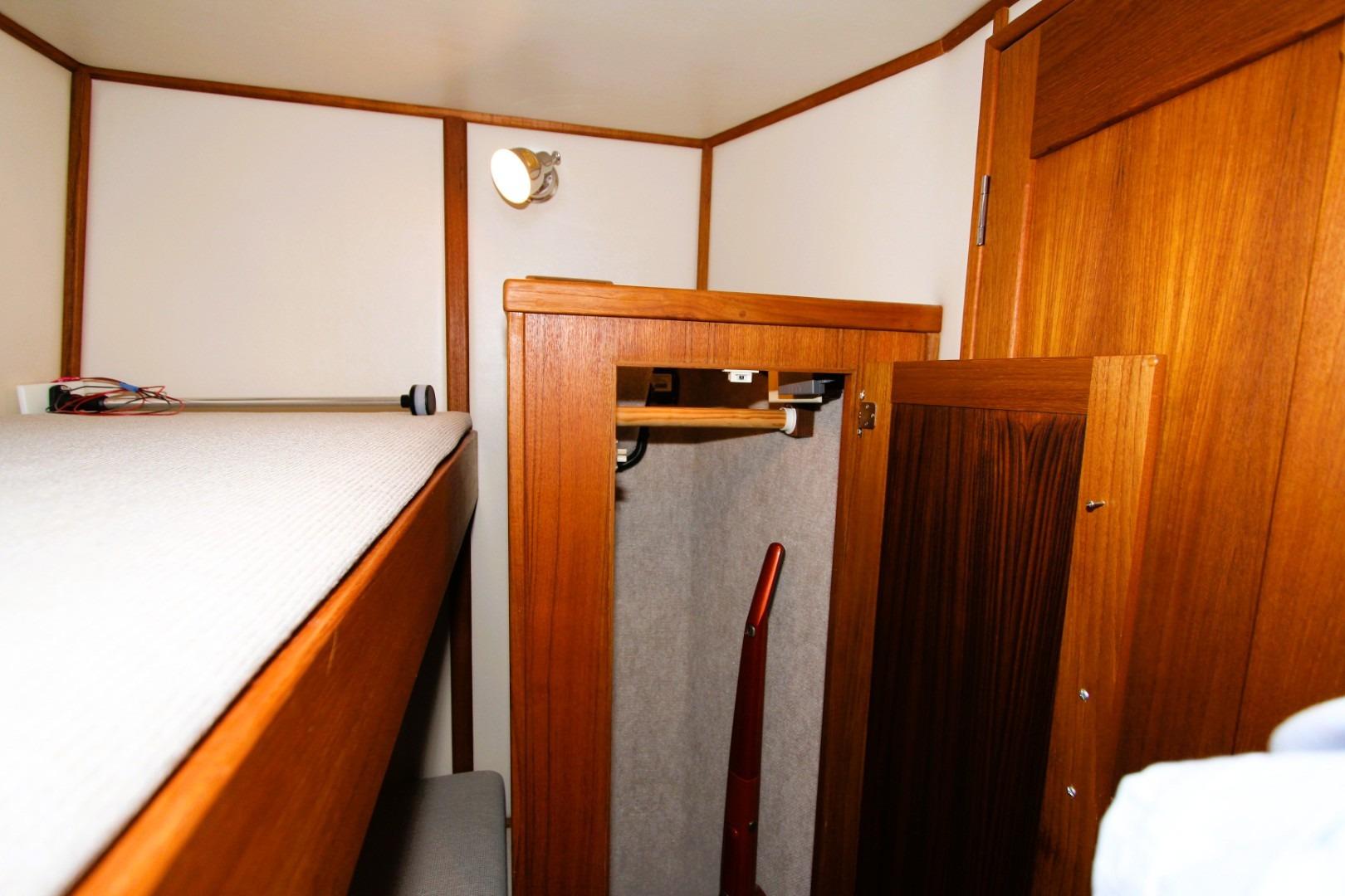 Interior of 2002 Nordic Tug 37, featuring wooden cabinetry and a cozy bunk area.