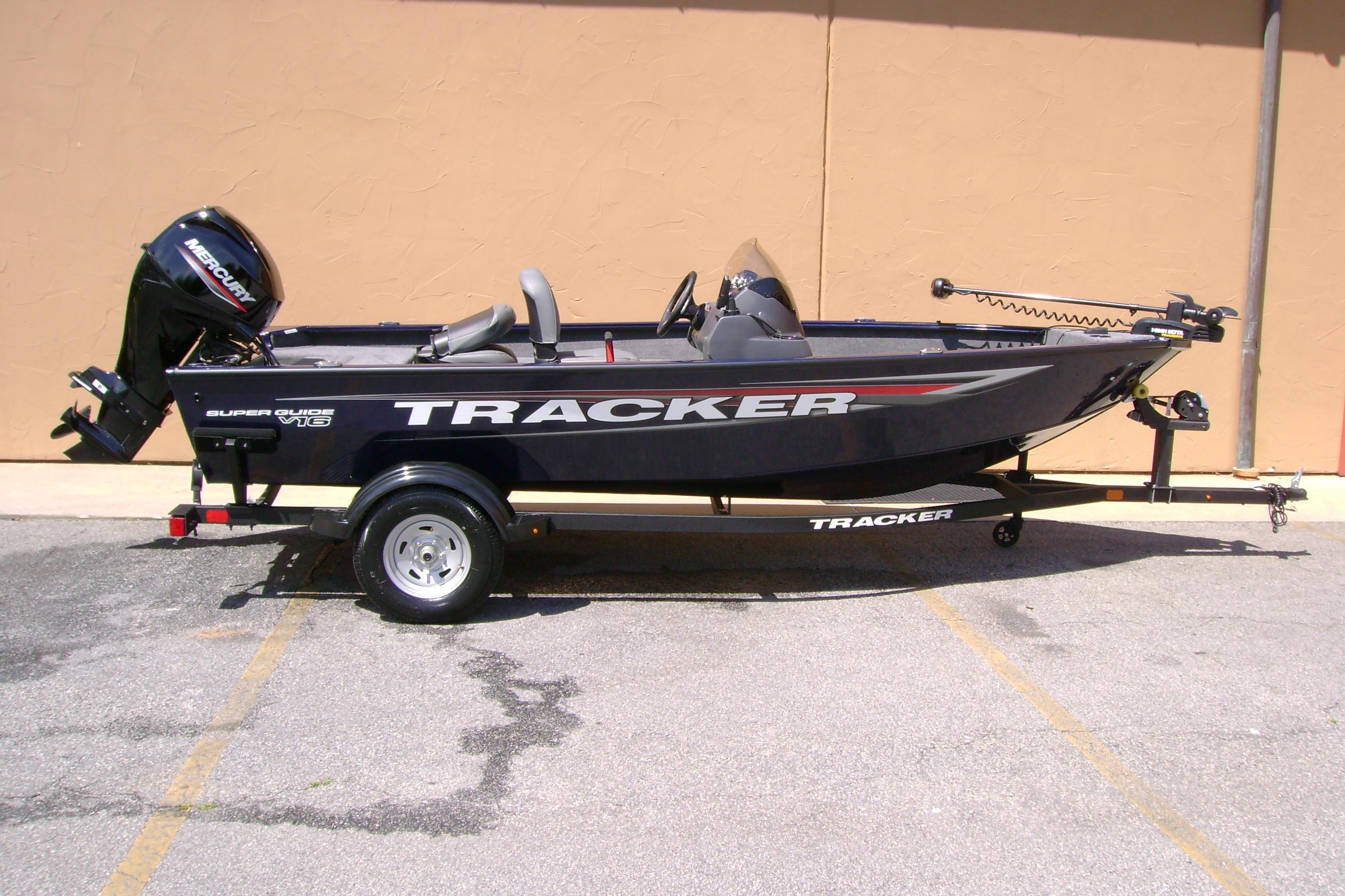 2026 Tracker Super Guide V-16 SC fishing boat on trailer, parked outdoors.