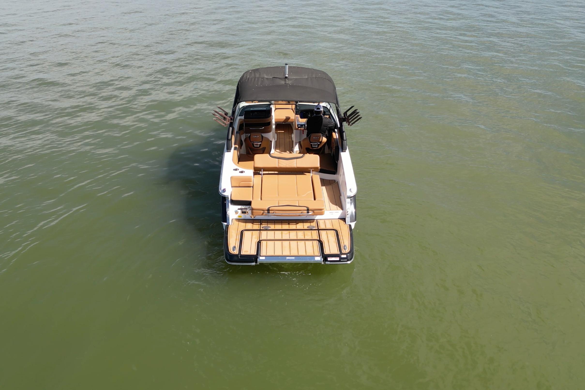2023 Chaparral 26 Surf boat on calm water, rear view.