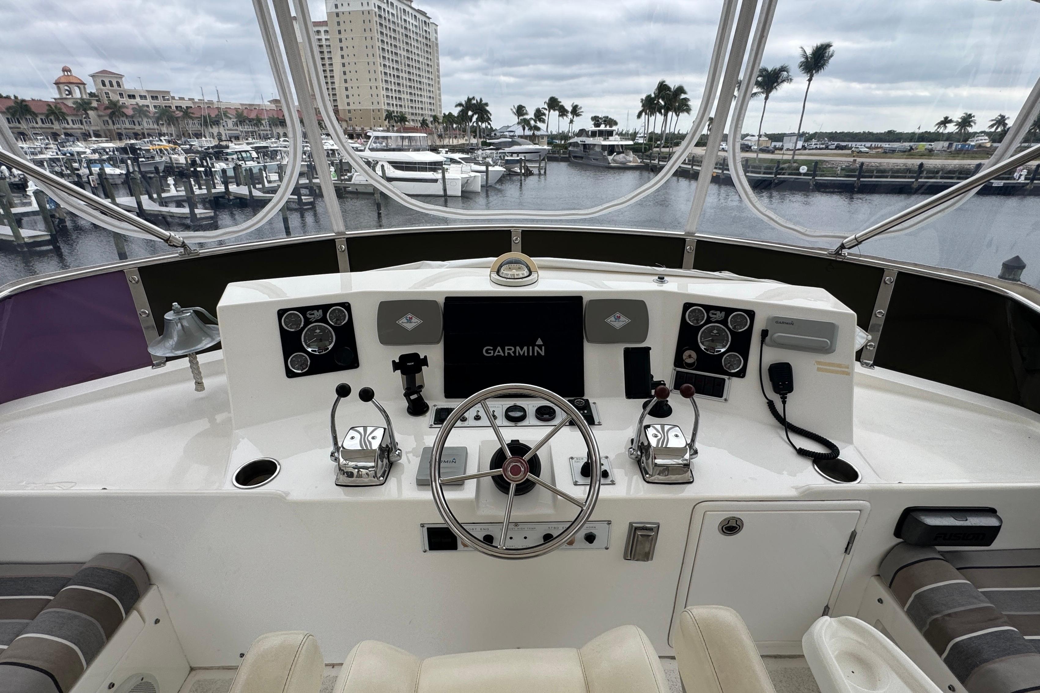 Cockpit of 2007 Jefferson Pilothouse 52 SE yacht with steering wheel and navigation controls.