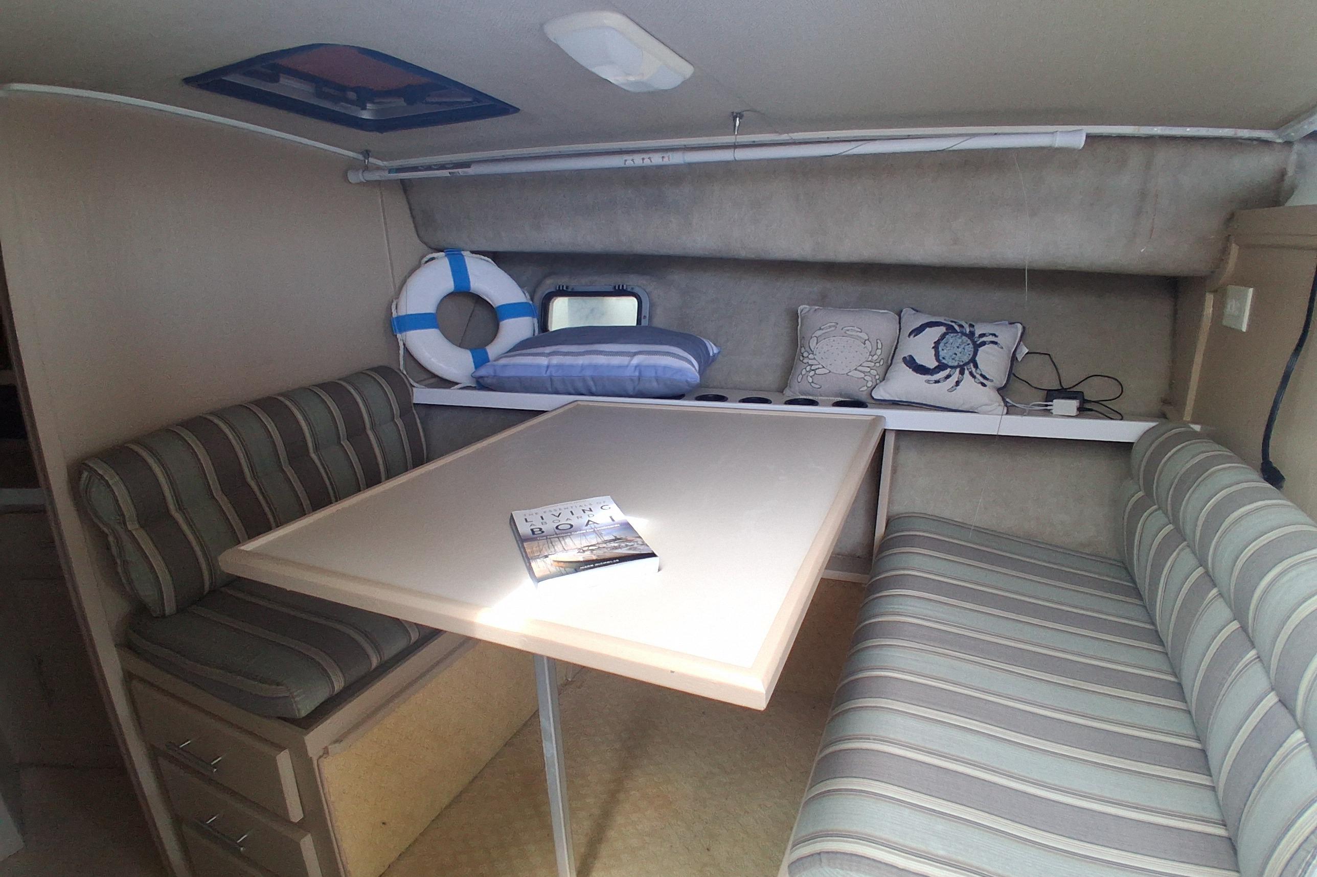 Interior of 1986 Silverton 34 Convertible with striped seating and nautical decor.