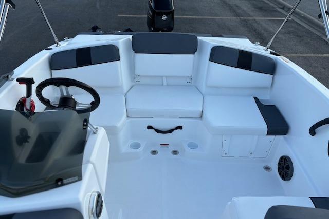 2026 Tahoe T16 boat interior with seating and steering wheel, showcasing modern design.