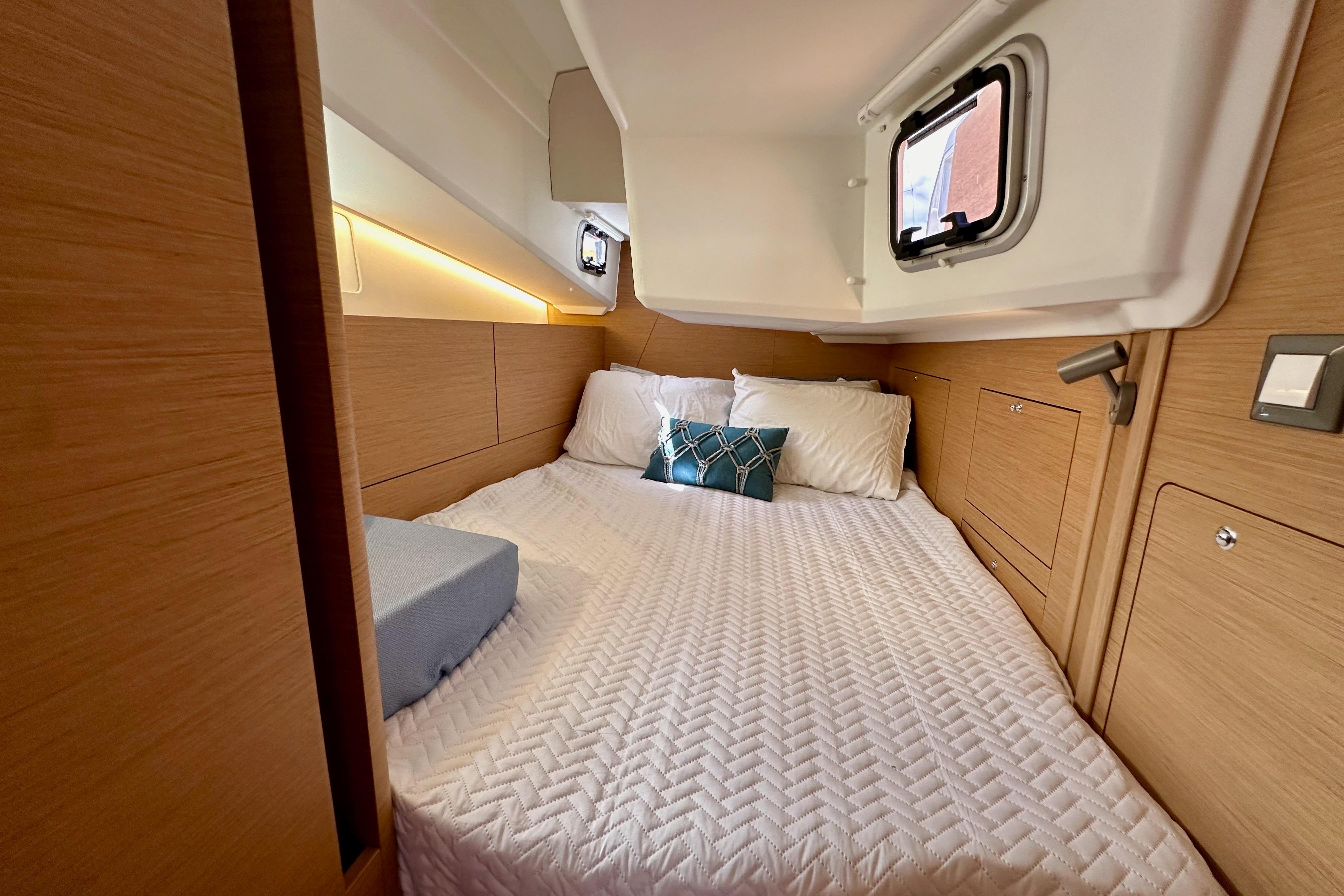2024 Jeanneau Sun Odyssey 410 cabin interior with cozy bed and modern design.