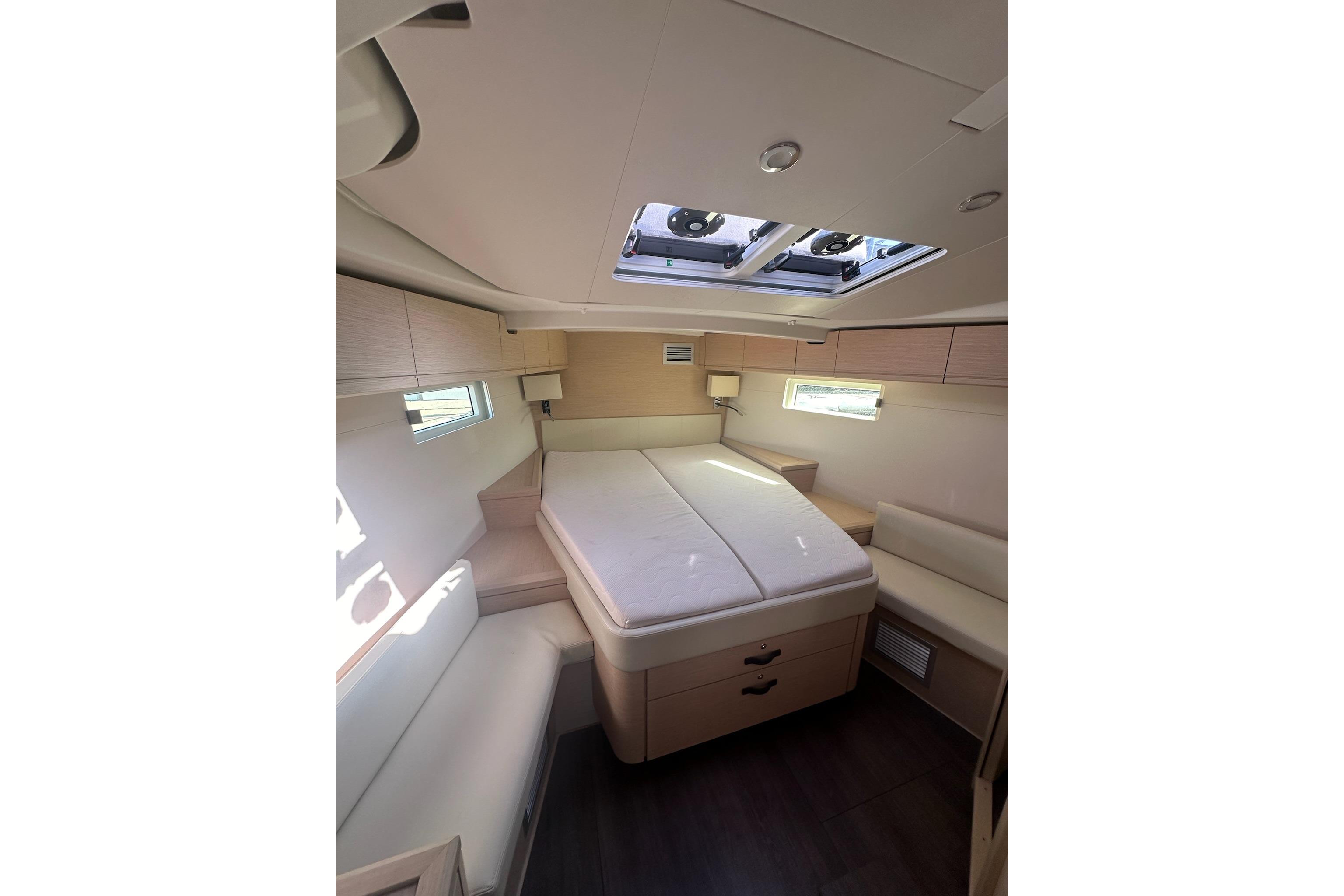 Luxurious interior cabin of 2018 Jeanneau 51 yacht with skylight and modern furnishings.
