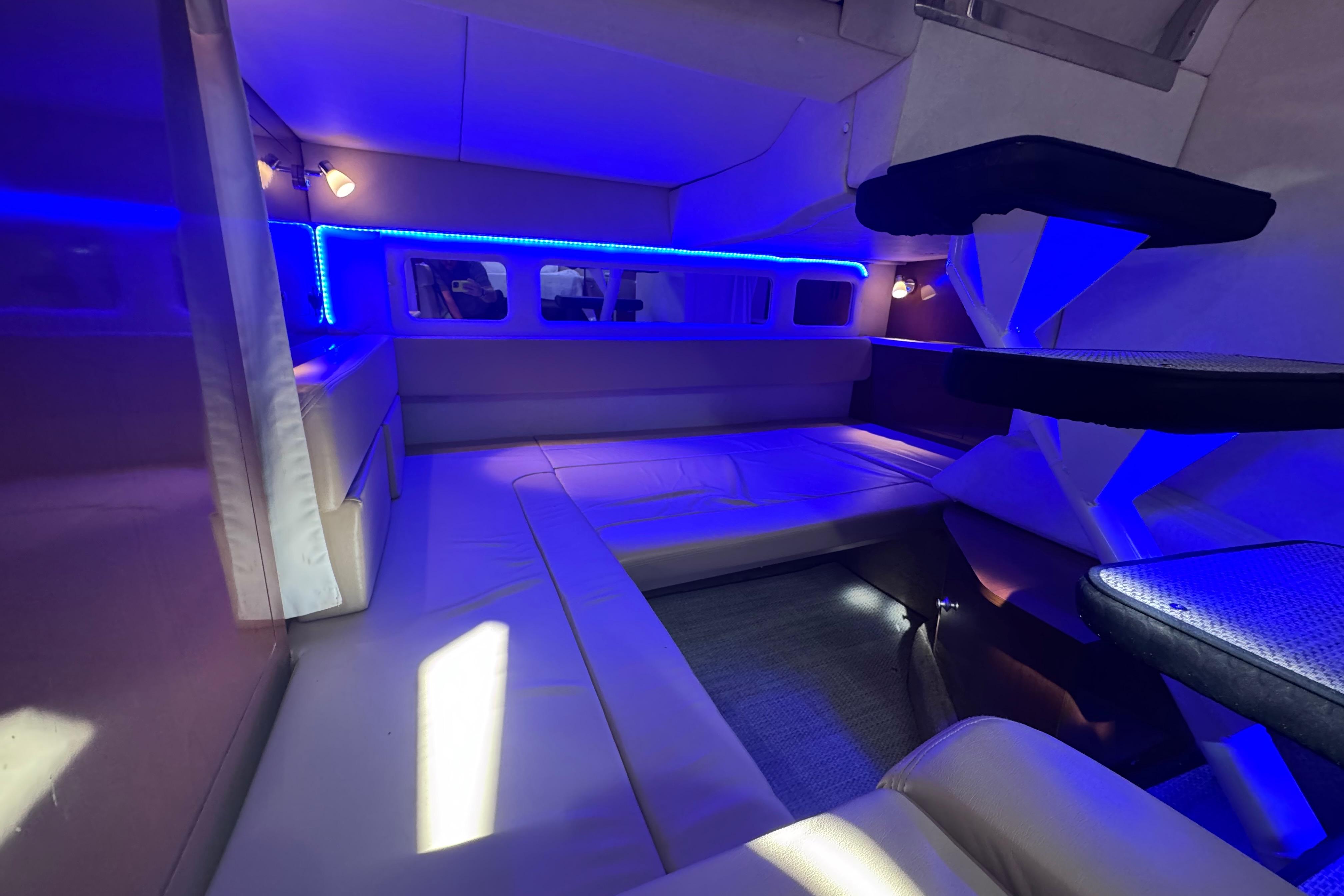 Luxurious interior of 2008 Sea Ray 350 Sundancer with blue LED lighting and plush seating.