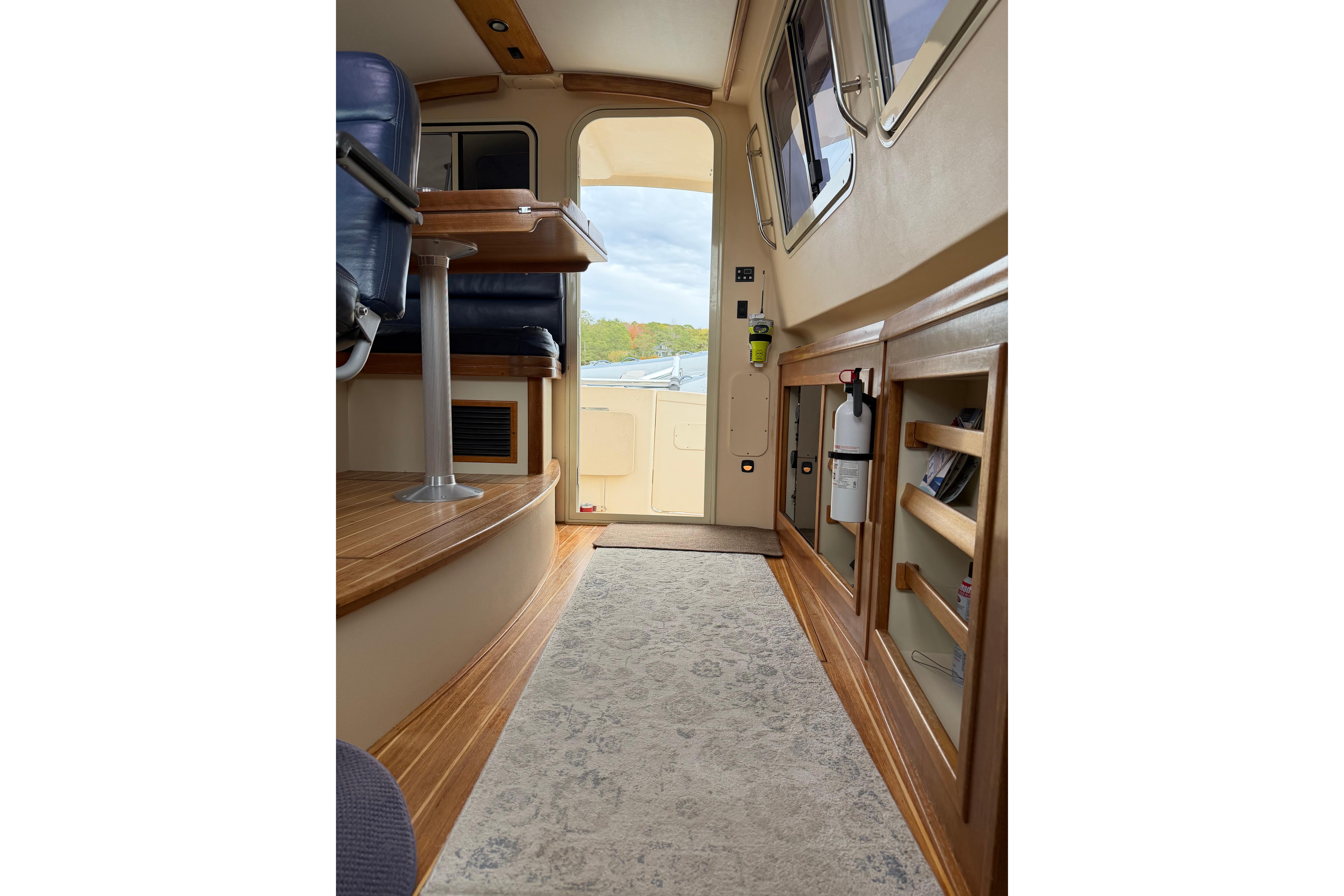 2008 Island Packet SP Cruiser interior with wood flooring and seating, showcasing elegant design.