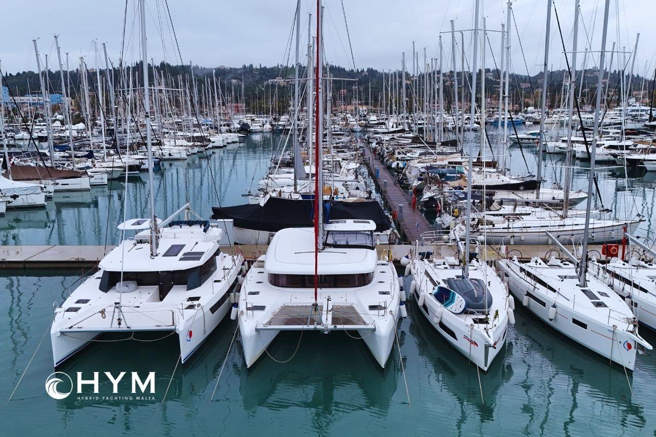 Marina with Lagoon 42 catamaran, 2020 model, surrounded by various yachts.