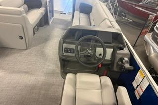 2026 Sun Tracker Party Barge 22 DLX interior with steering console and seating.