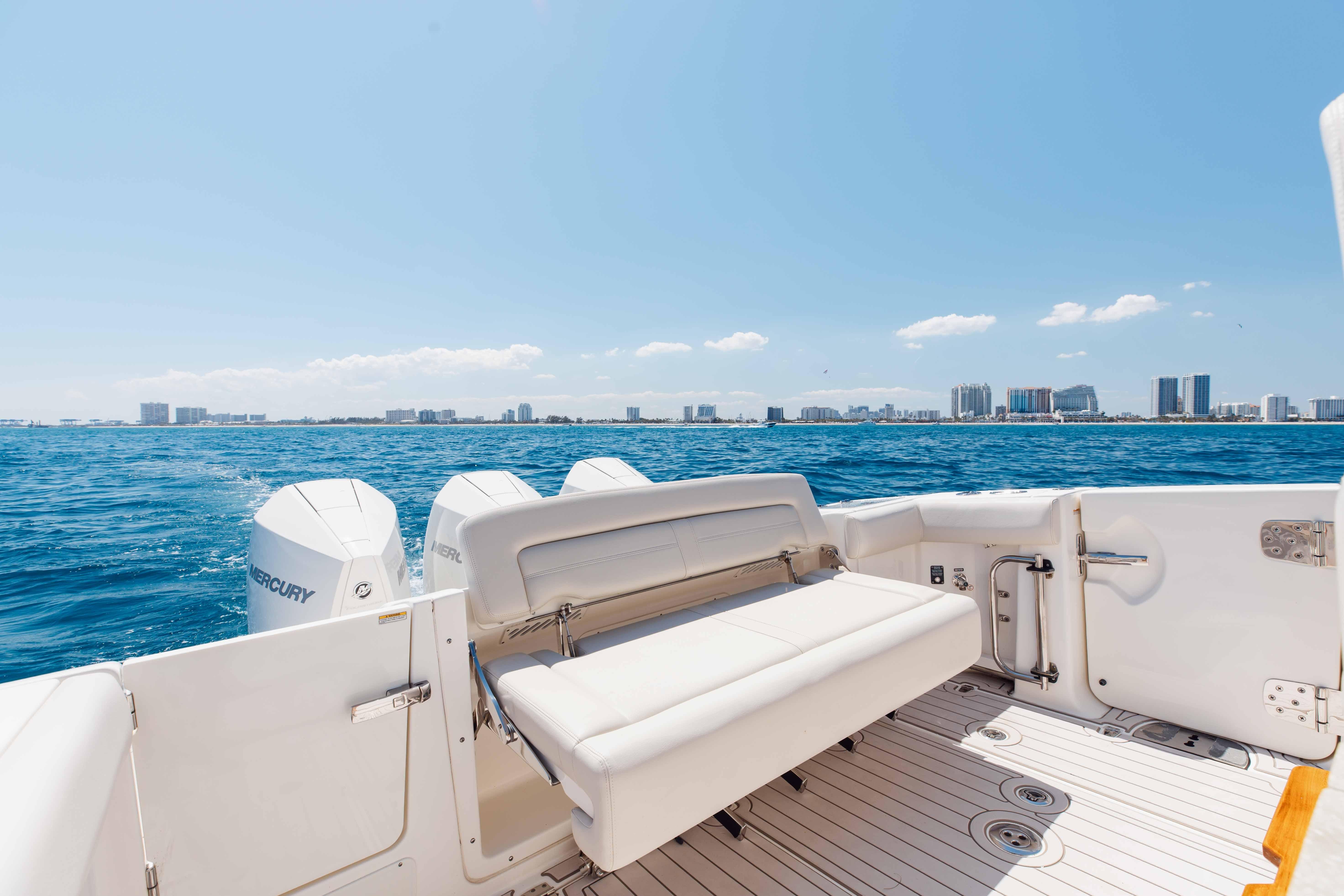 Boston Whaler 350 Realm 2021 boat with city skyline and ocean view.