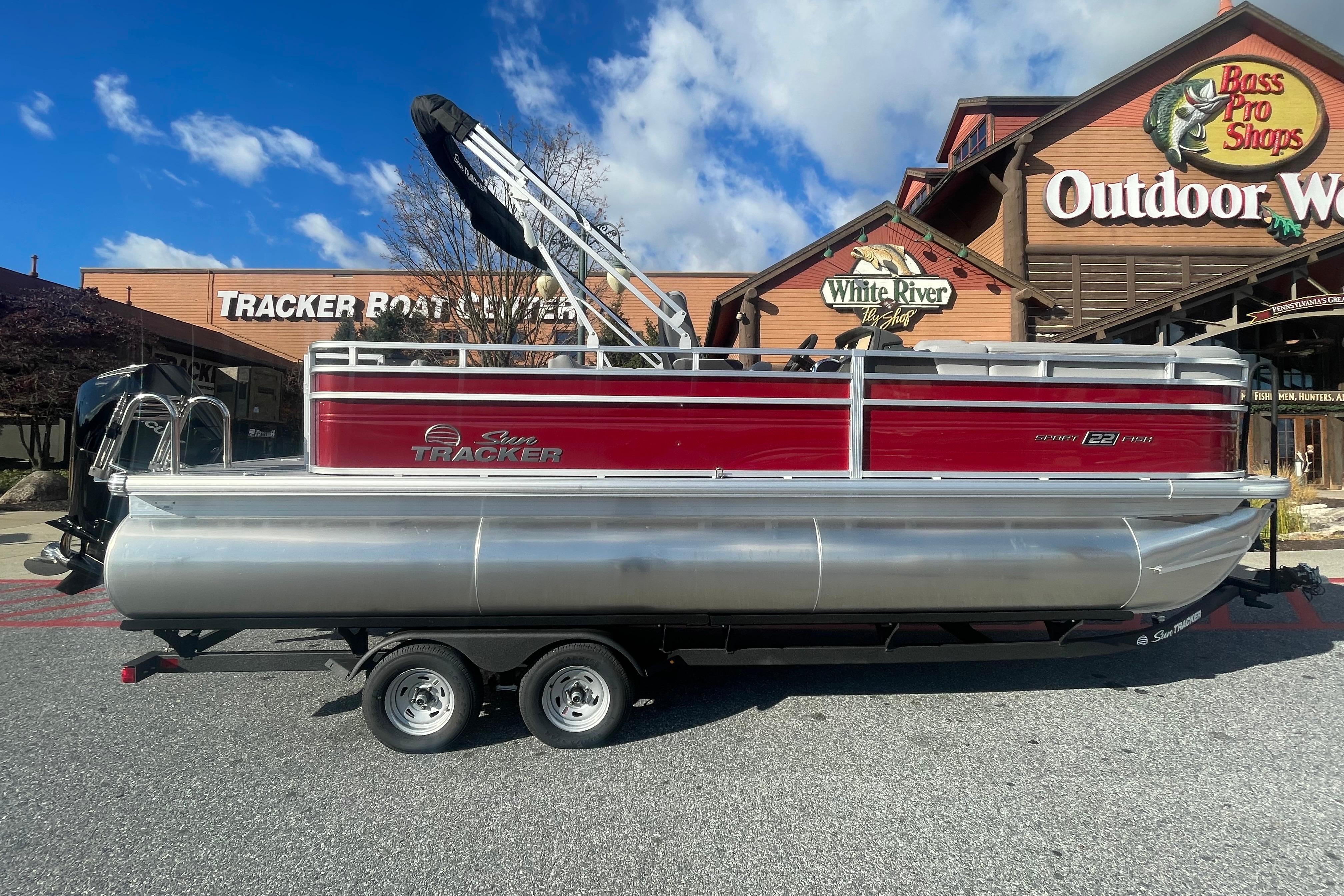 2026 Sun Tracker SportFish 22 XP3 pontoon boat outside Bass Pro Shops.