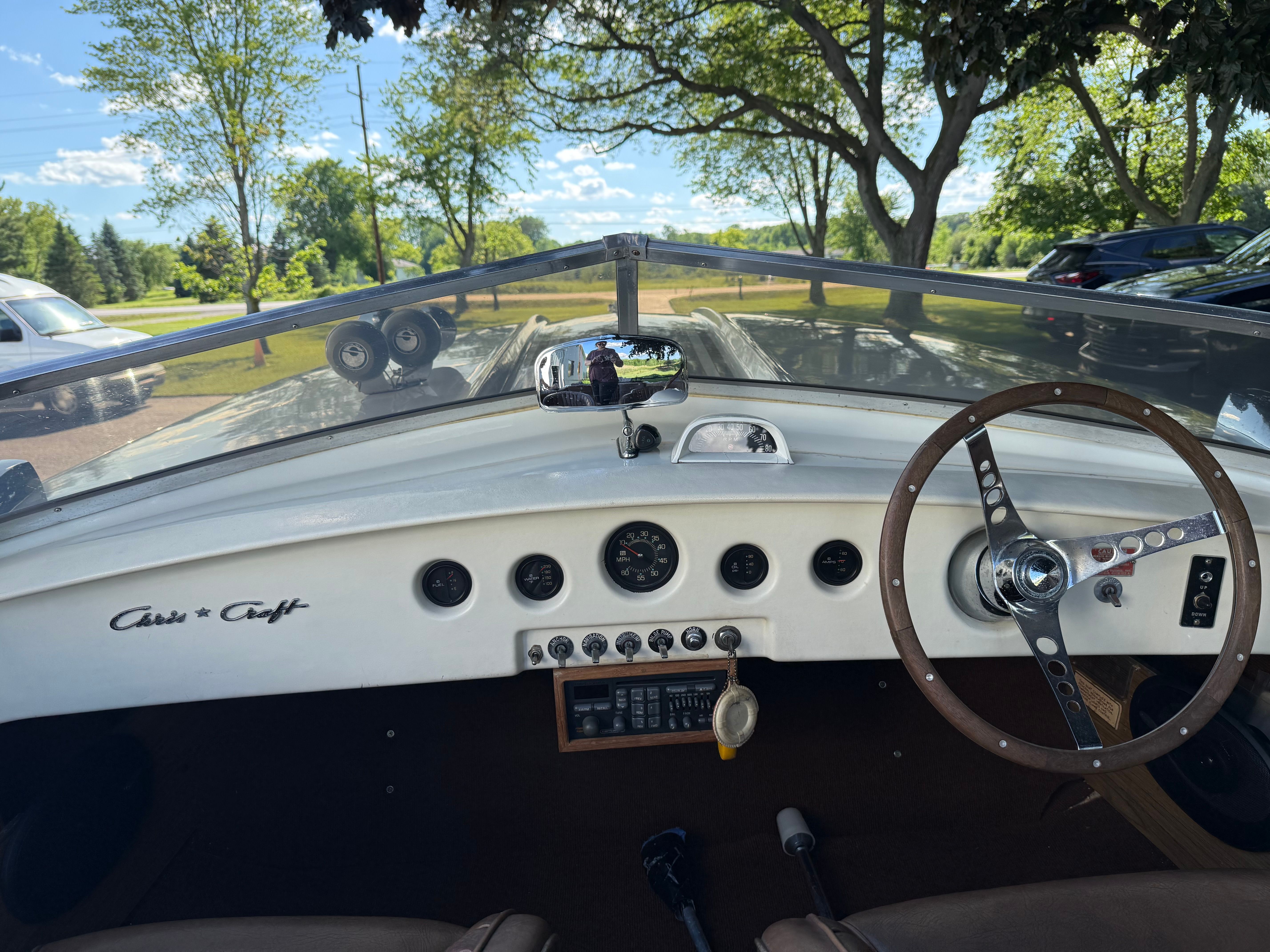 The cockpit of a 1972 Chris-Craft XK-19 with classic steering wheel and dashboard.