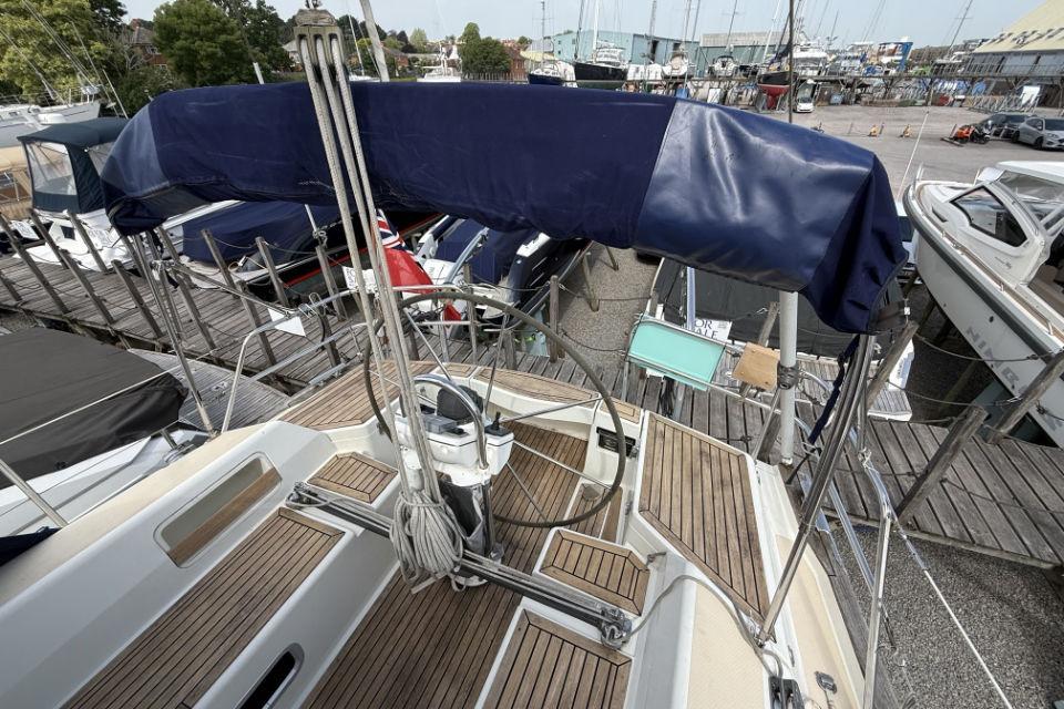 2005 Southerly 35RS sailboat deck with covered helm, docked at marina.