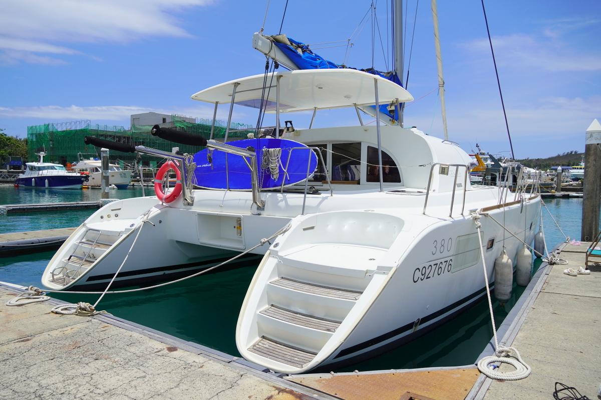 2013 Lagoon 380 S2 catamaran docked at marina, featuring spacious deck and modern design.