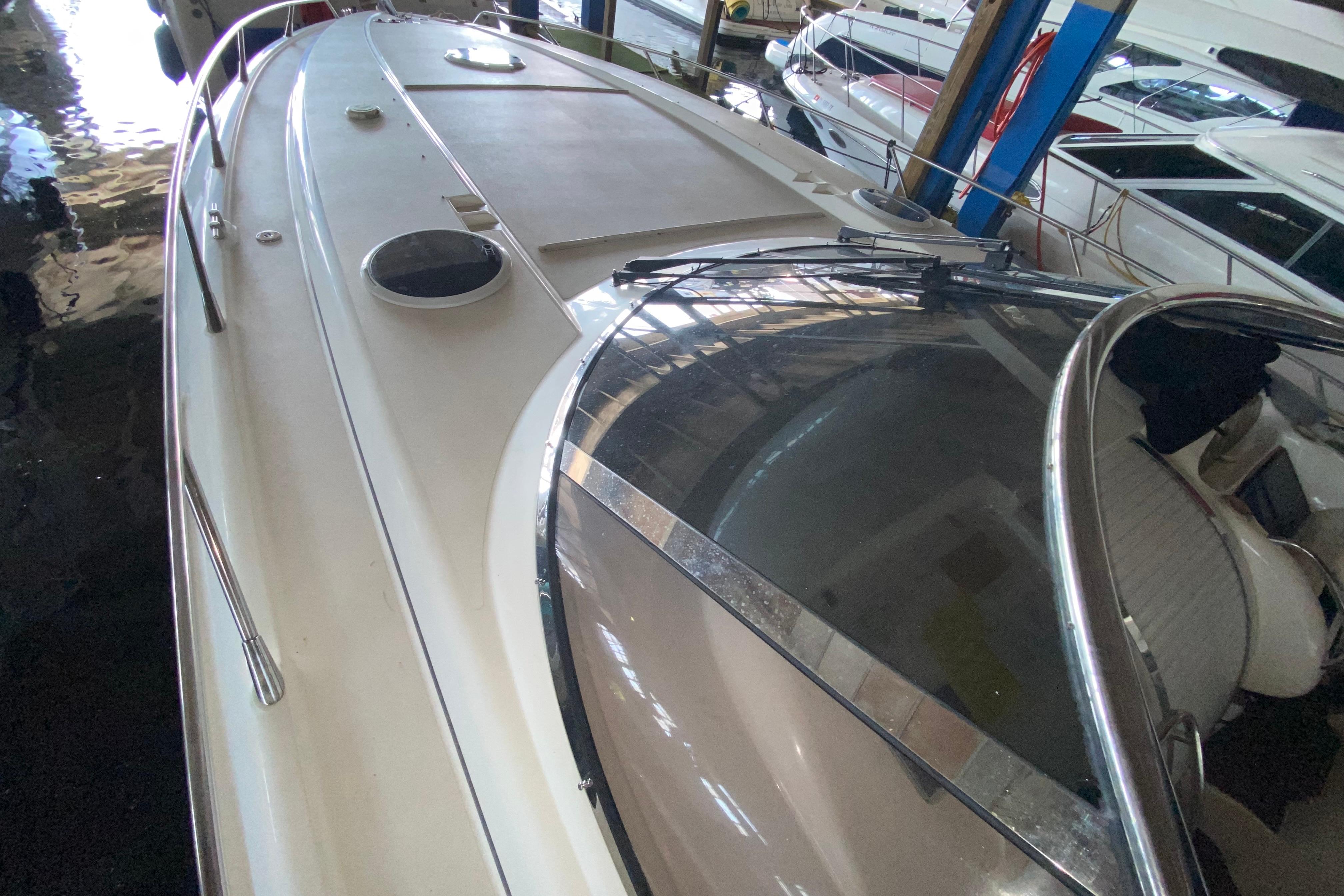 1997 Sunseeker Camargue 51 yacht docked indoors, showcasing sleek design and spacious deck.