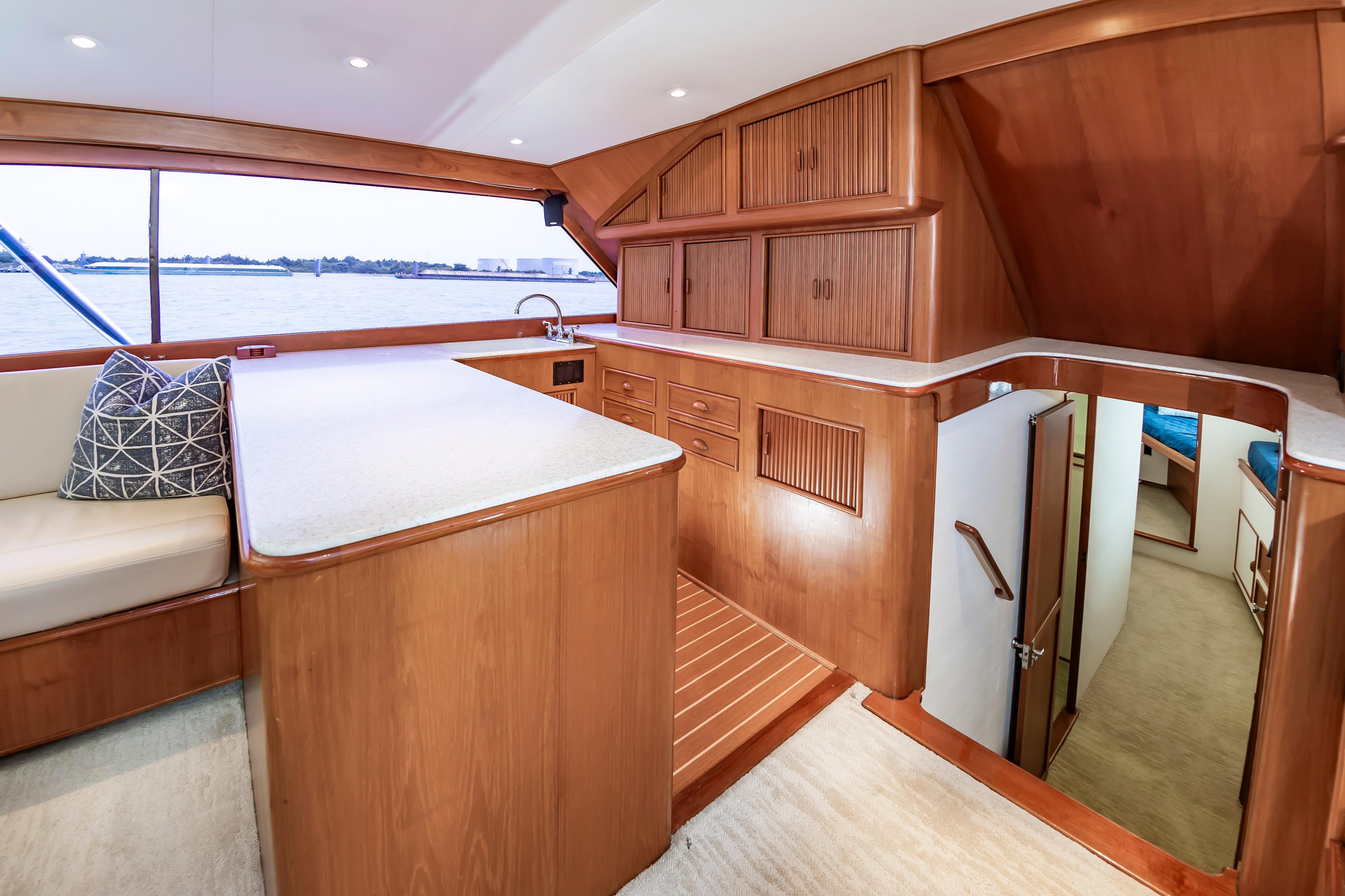 Interior of 1993 Custom Carolina Scarborough 56 Convertible yacht with wooden cabinetry and seating.