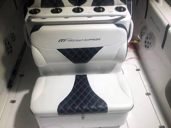 2019 Midnight Express 39 Cuddy boat interior with cushioned seating and cup holders.