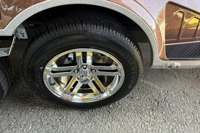 2026 Ranger Z521R Cup-Equipped vehicle with shiny chrome wheel on asphalt surface.