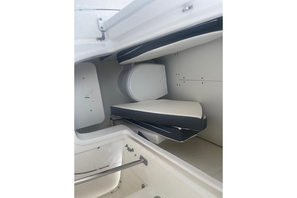 2024 Robalo R230 Center Console interior with seating and storage area.