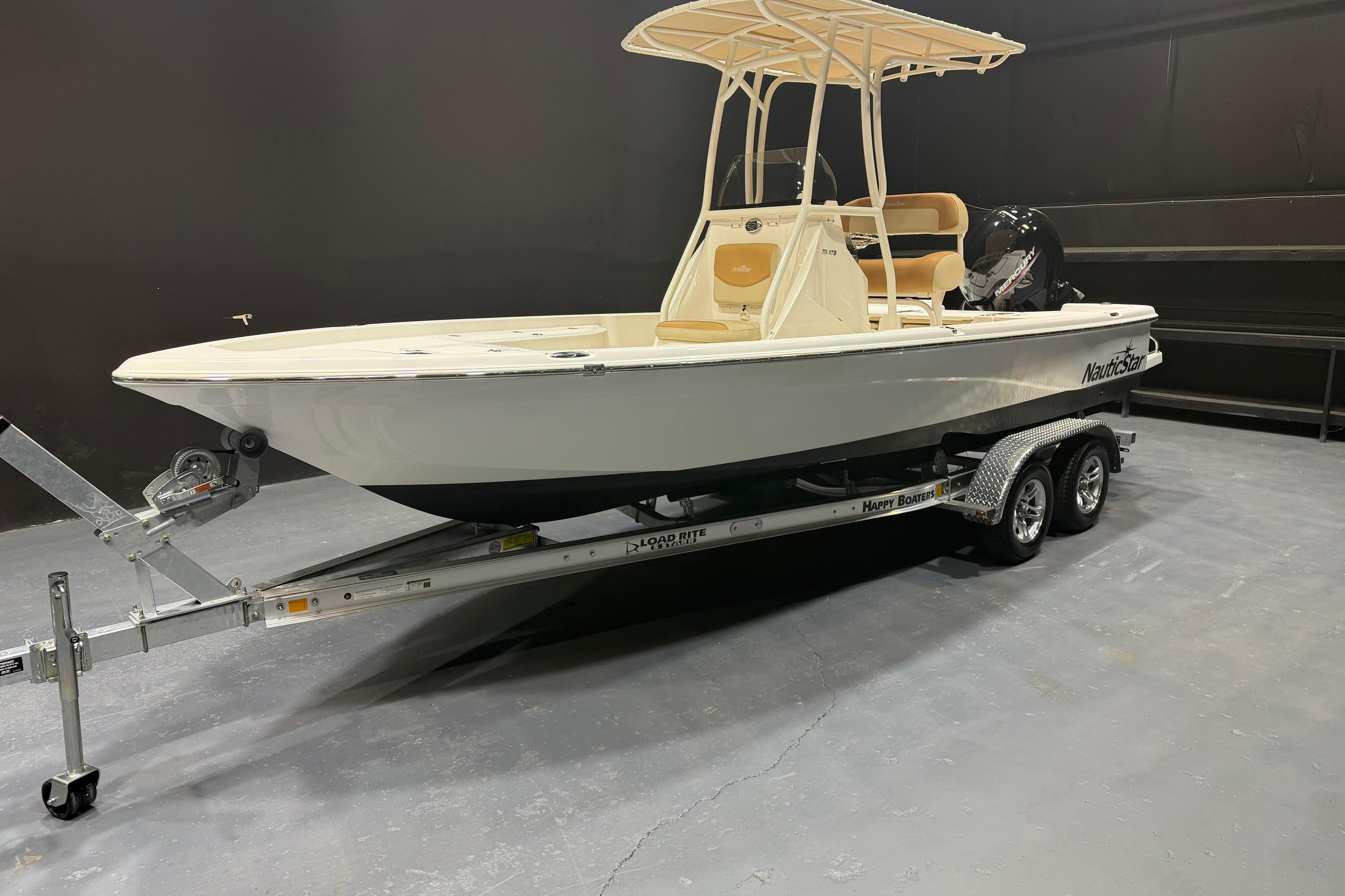 2023 NauticStar 215 XTS boat on trailer in indoor setting.