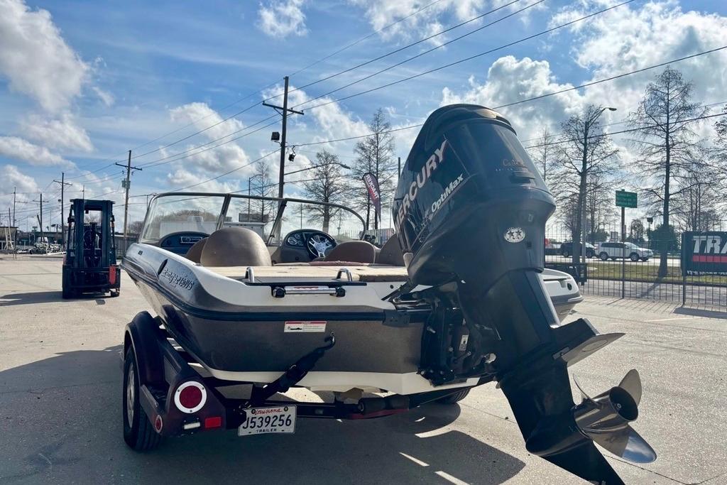 2008 Ranger 180 Reata boat with Mercury engine on trailer, parked outdoors.