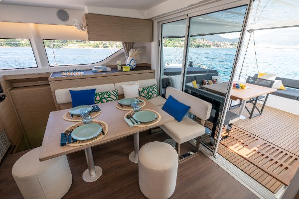 Luxurious interior of 2025 Lagoon 43 yacht with elegant dining area and scenic ocean view.