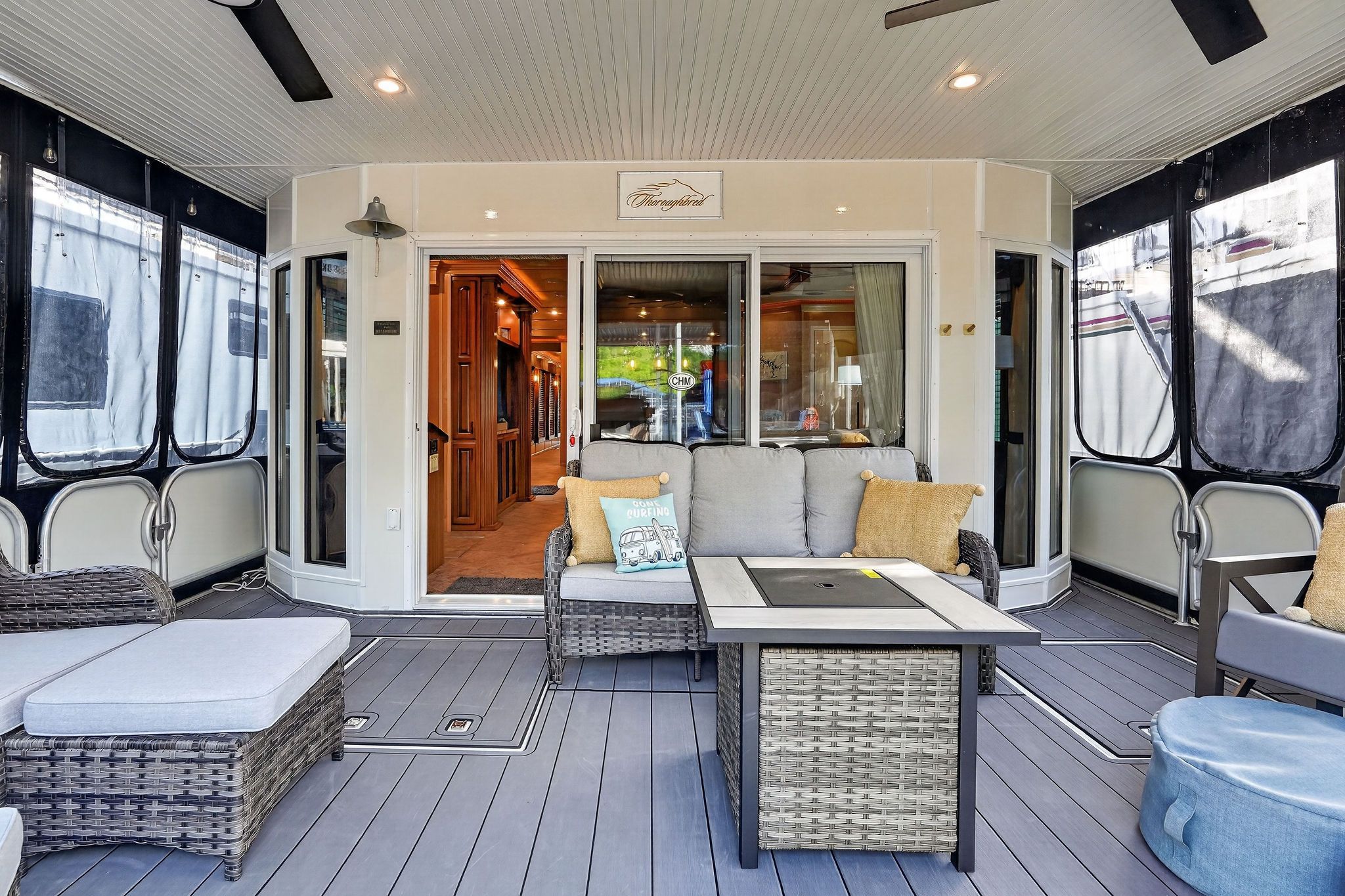 2010 Houseboat Throughbred with cozy outdoor seating and modern furniture.
