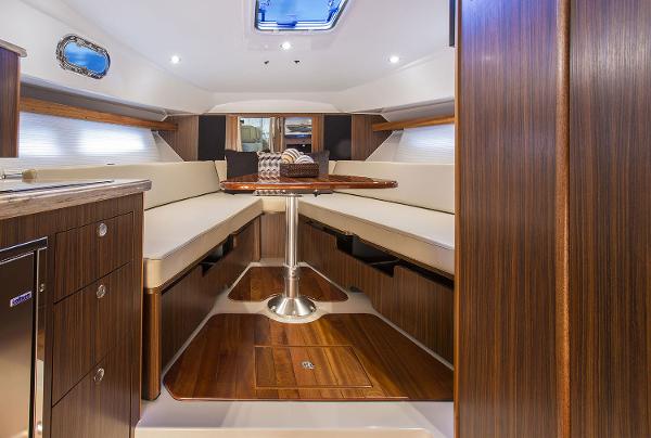 Manufacturer Provided Image: 2019 Pursuit OS 355 Offshore cabin with elegant wood finish and cozy seating area.
