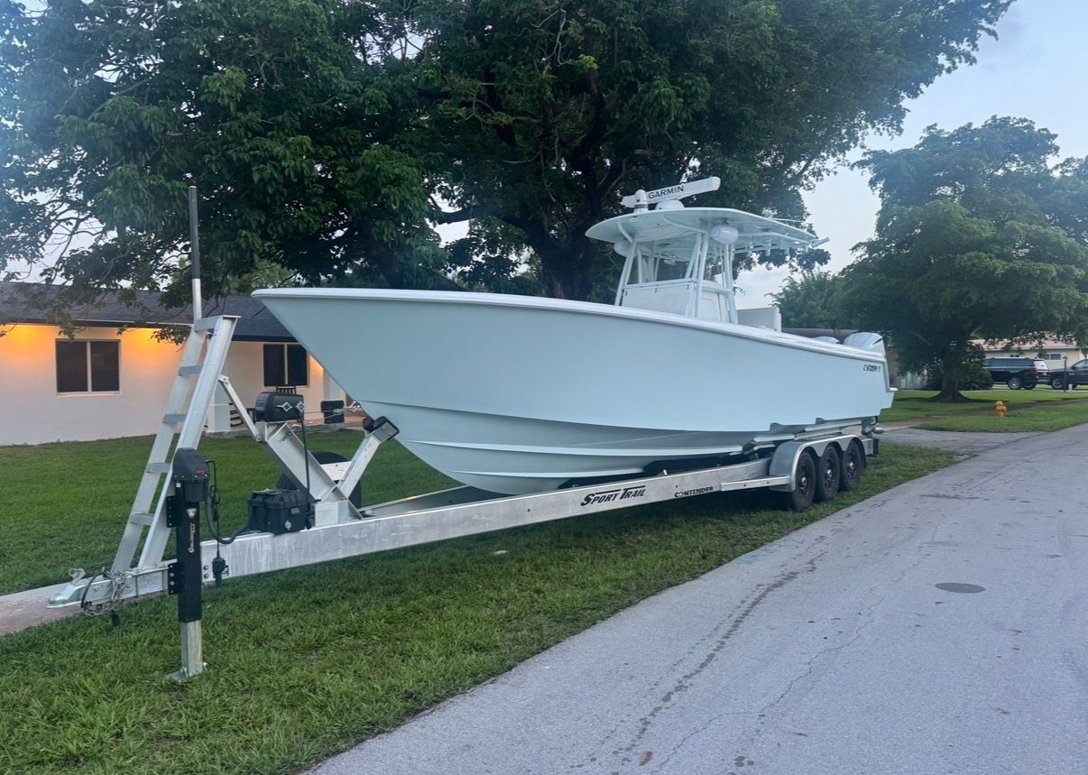 2019 Contender 35 ST boat on trailer, parked on street.