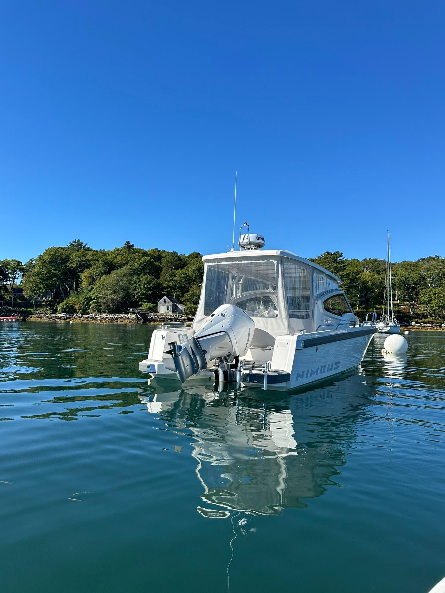 Nimbus W9 2021 boat on calm water with clear blue sky.