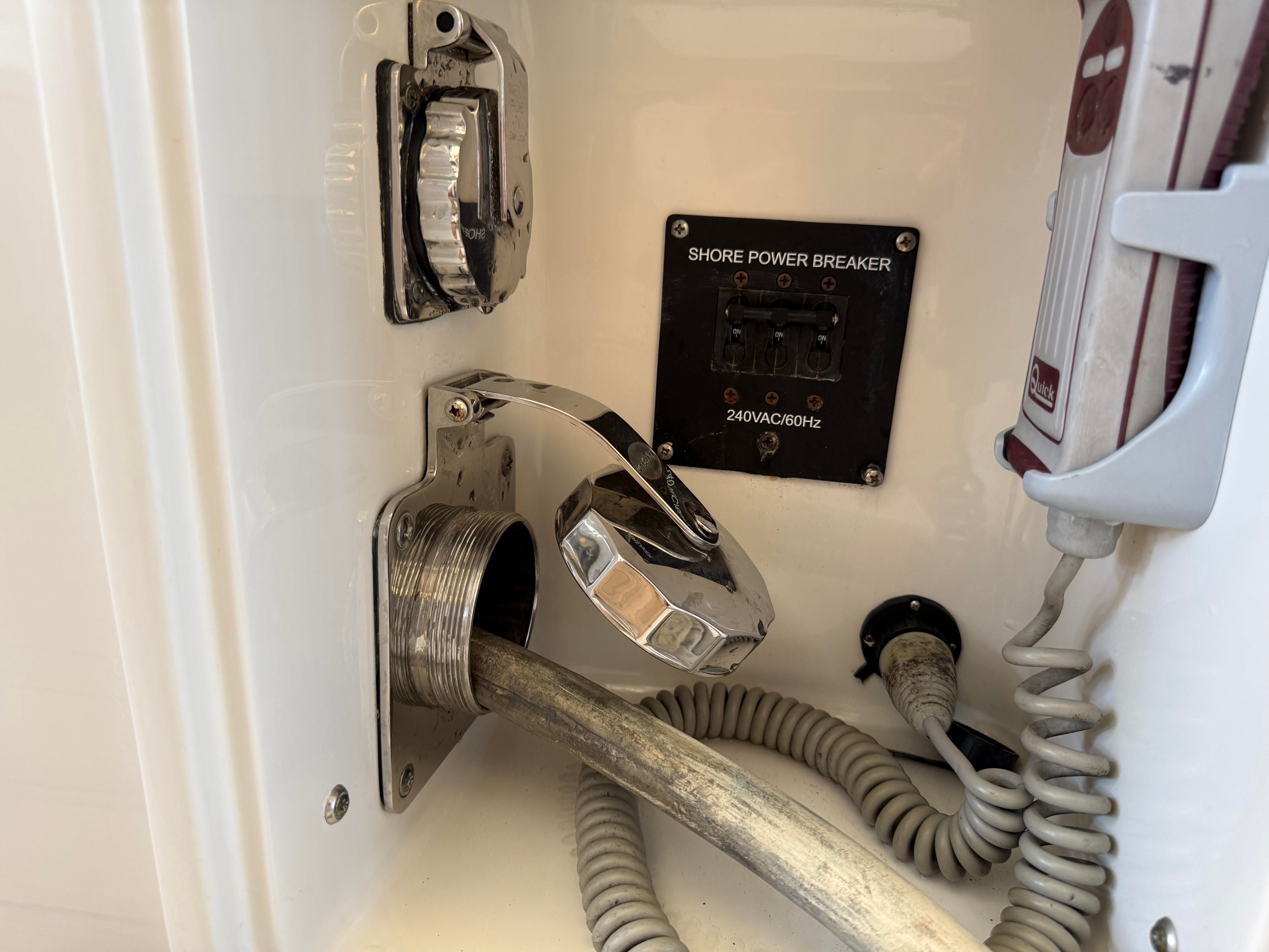Close-up of a power connection with cable and switch.