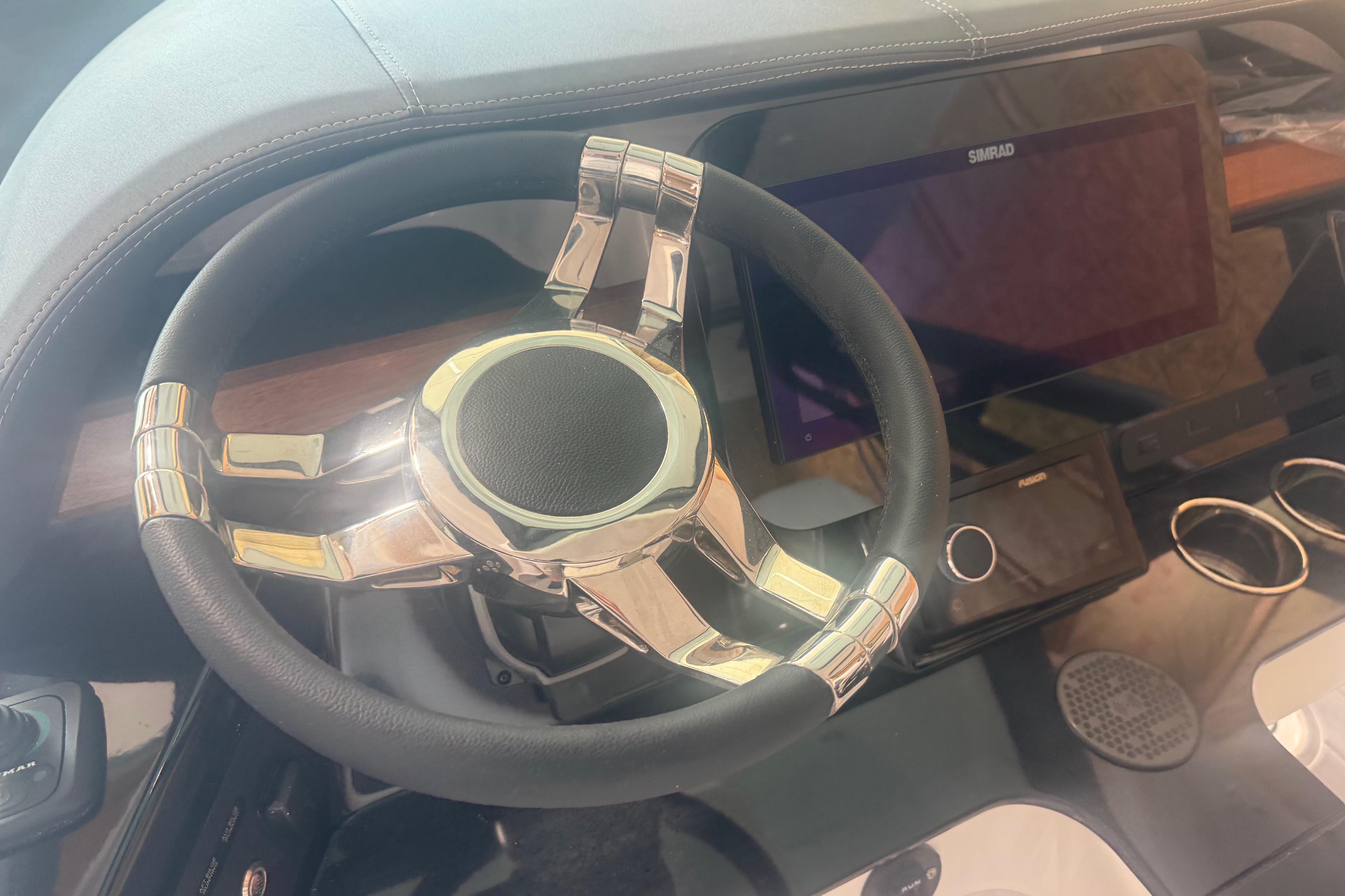 Steering wheel and dashboard of 2027 Monterey Elite 27 SD boat.
