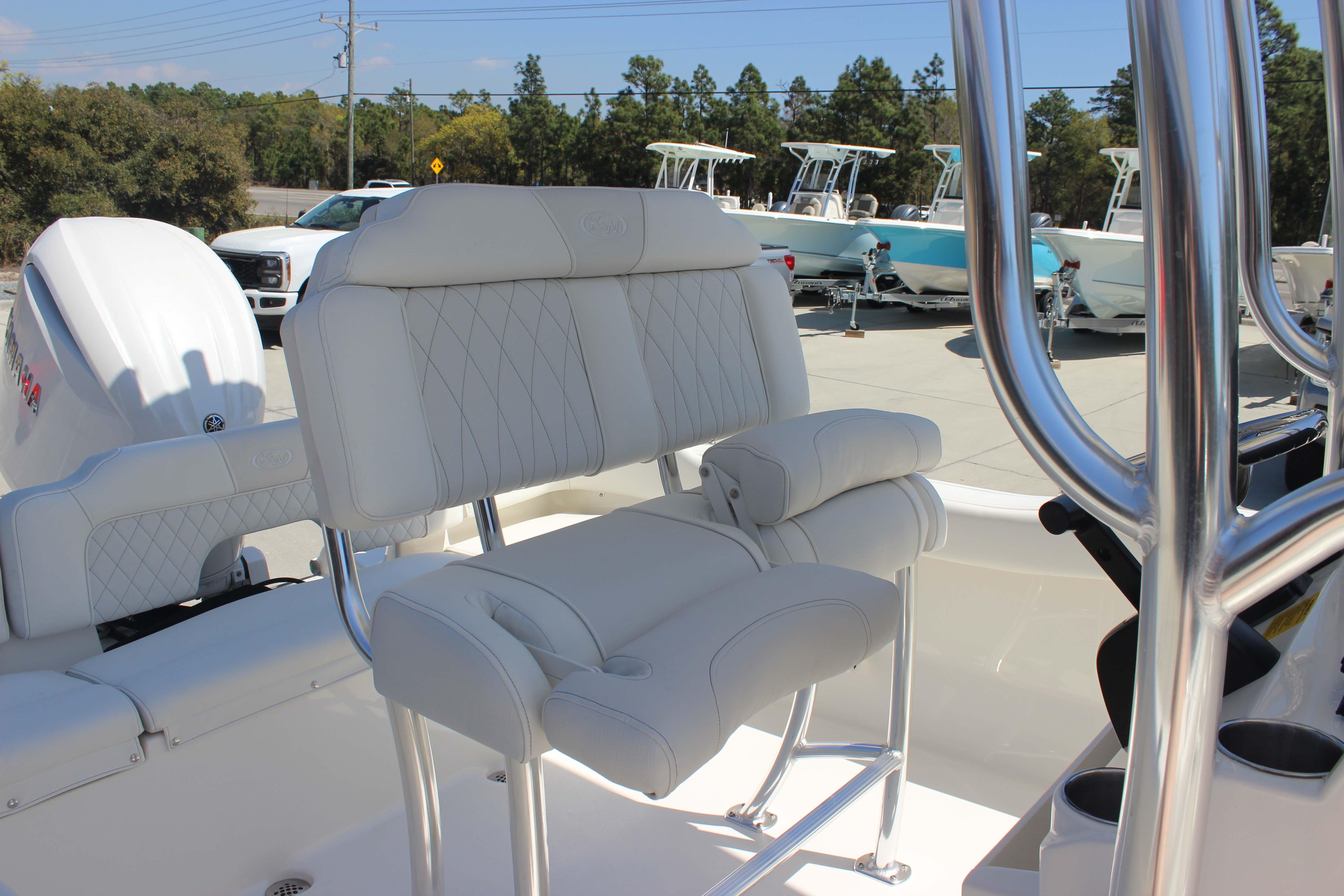 2026 Key West 203 FS boat interior with white cushioned seating and stainless steel details.