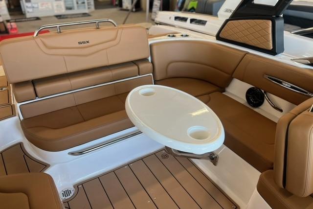 Interior of 2025 Chaparral 247 SSX boat with tan seating and white table.