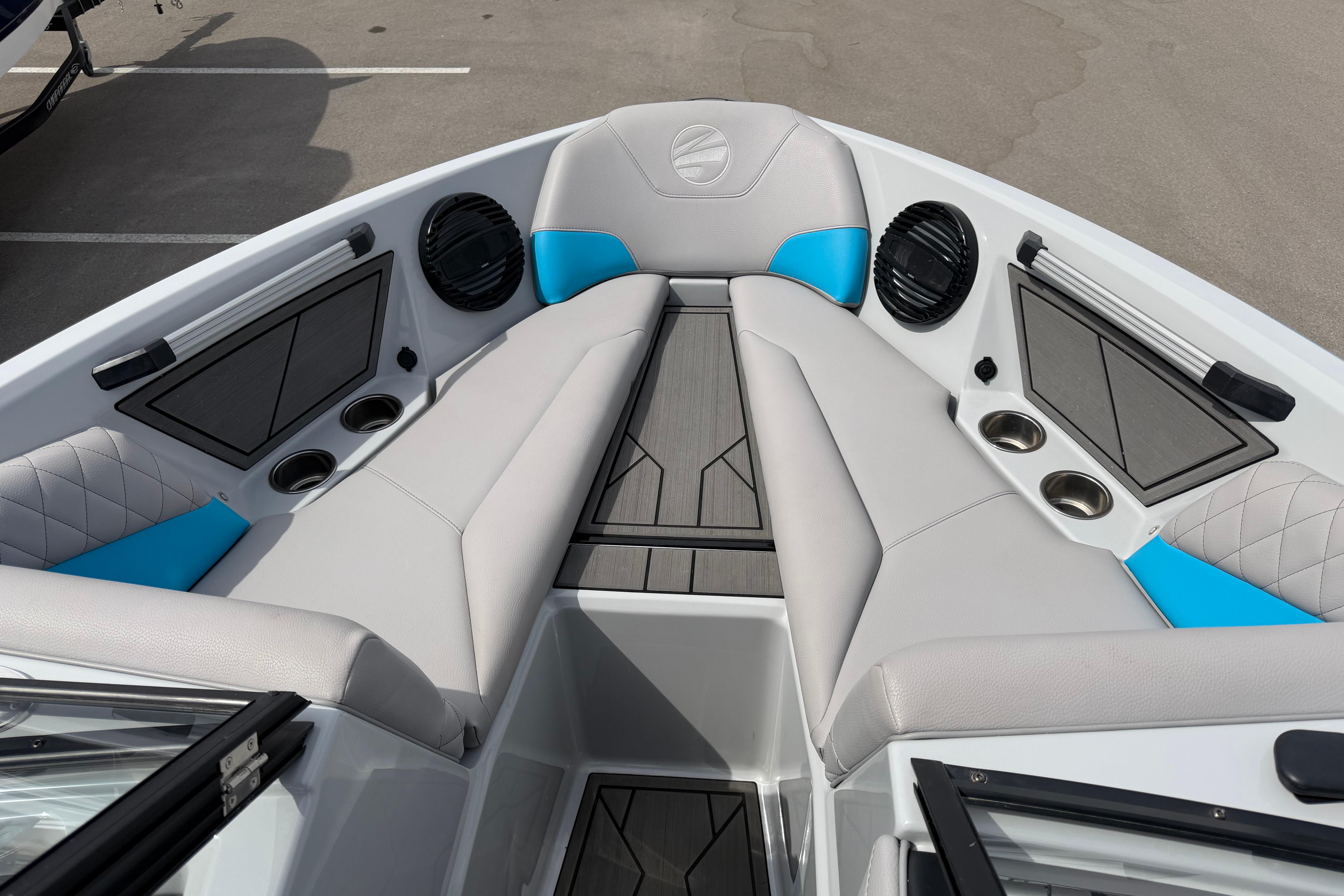 2024 Tigé Z1 boat interior with gray and blue seating, cup holders, and speakers.