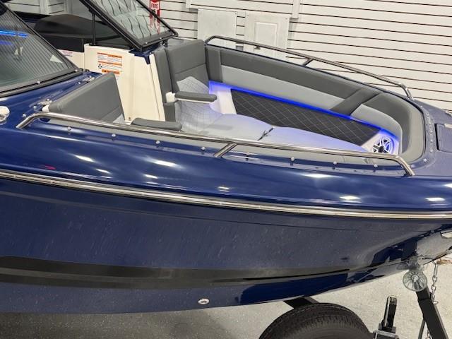 2026 Chaparral SSX 6 boat, blue exterior, sleek design, modern interior lighting.