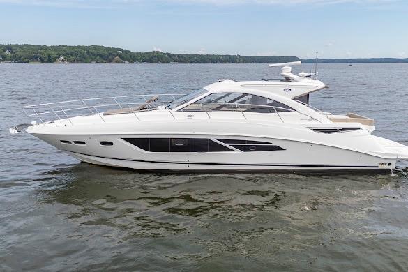 2016 Sea Ray Sundancer 510 yacht cruising on a calm lake under a clear sky.