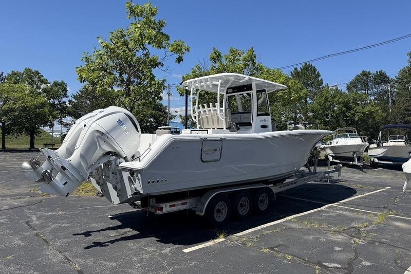 2026 Sea Hunt Gamefish 30 boat on trailer in parking lot, sunny day.
