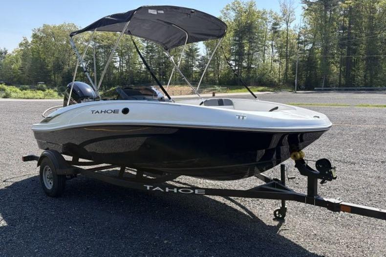 2026 Tahoe T16 boat on trailer with canopy, parked outdoors.