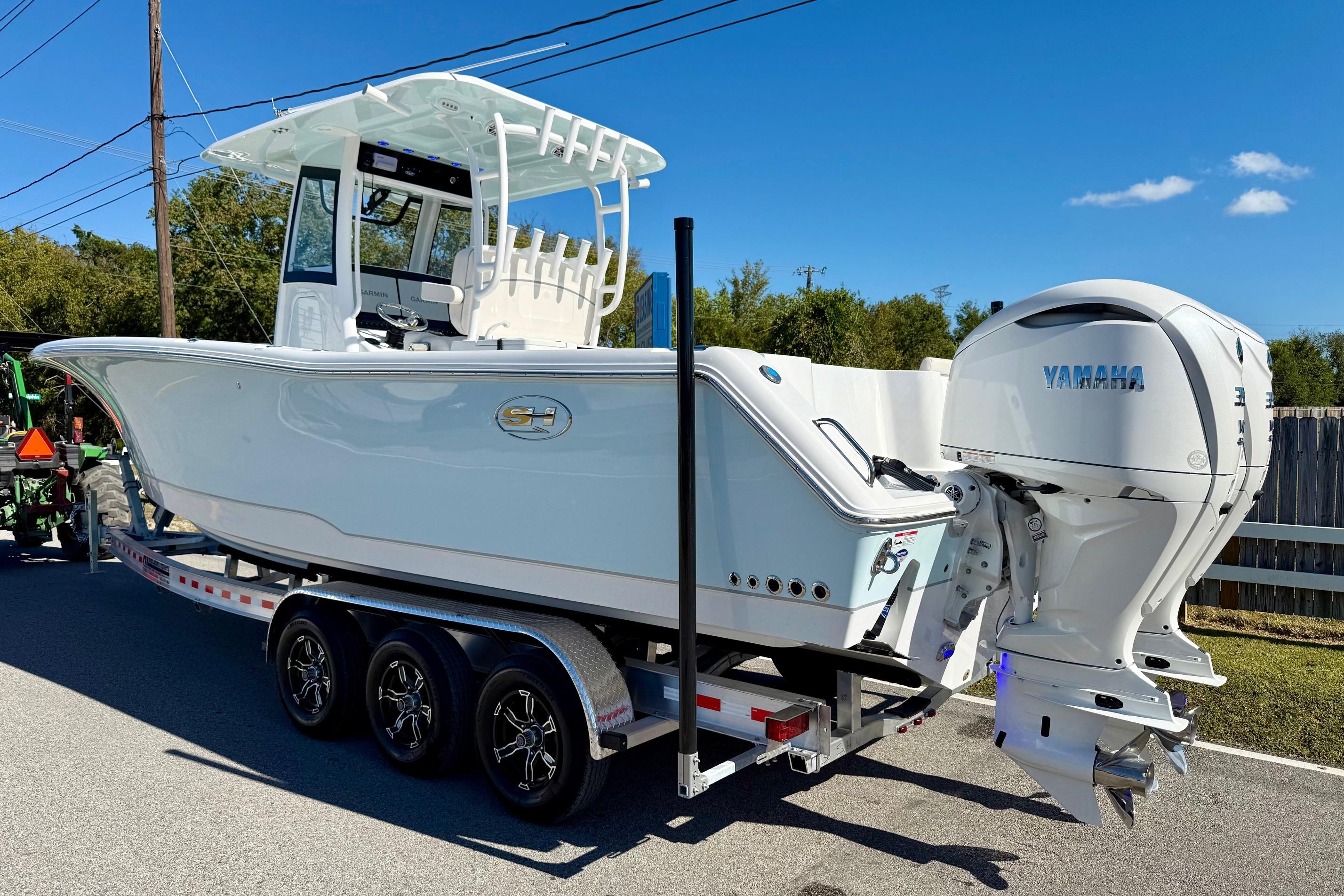 2026 Sea Hunt Gamefish 30 Coffin Box boat with Yamaha engines on a trailer.