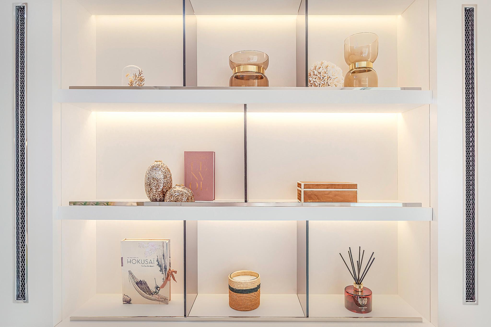 Elegant shelving with decorative items on a Lagoon SIXTY 5, 2025 model yacht.